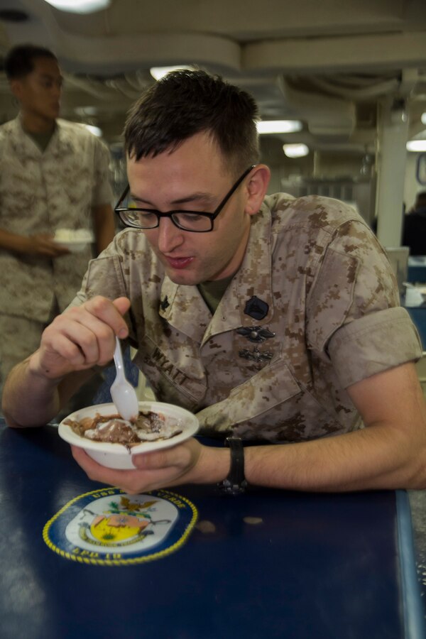 U.S. 5TH FLEET AREA OF RESPONSIBILITY (July 5, 2014) U.S. Navy Hospitalman 3rd Class Ryan Wyatt, Combat Logistics Battalion 22, 22nd Marine Expeditionary Unit (MEU), corpsman and native of North Wilkesboro, N.C., eats ice cream during an ice cream social aboard the amphibious transport dock ship USS Mesa Verde (LPD 19). The 22nd MEU is deployed with the Bataan Amphibious Ready Group as a theater reserve and crisis response force throughout U.S. Central Command and the U.S. 5th Fleet area of responsibility. (U.S. Marine Corps photo by Cpl. Manuel A. Estrada/Released)