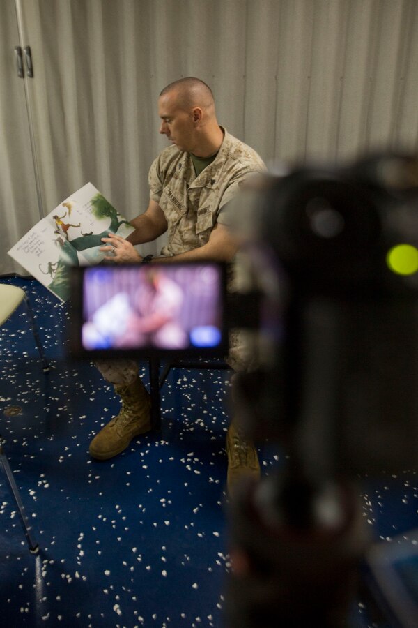 U.S. 5TH FLEET AREA OF RESPONSIBILITY (July 6, 2014) U.S. Marine Corps Cpl. Andrew Manning, Combat Logistics Battalion 22, 22nd Marine Expeditionary Unit (MEU), administration noncommissioned officer in charge and native of Kinston, N.C., participates in the “United Through Reading” program by recording himself reading to his child aboard the amphibious transport dock ship USS Mesa Verde (LPD 19). The 22nd MEU is deployed with the Bataan Amphibious Ready Group as a theater reserve and crisis response force throughout U.S. Central Command and the U.S. 5th Fleet area of responsibility. (U.S. Marine Corps photo by Cpl. Manuel A. Estrada/Released)