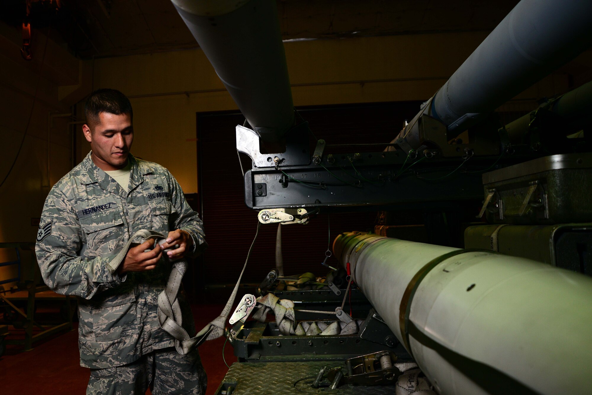Staff Sgt. Eduardo Hernandez applies the final touches to a missile set for an F-16 Fighting Falcon June 11, 2014, on Misawa Air Base, Japan. Hernandez, a 35th Maintenance Squadron precision-guided munitions crew chief, said the feeling of seeing a jet come back empty after using munitions he loaded is incomparable to anything in this world. (U.S. Air Force photo/Senior Airman Derek VanHorn)