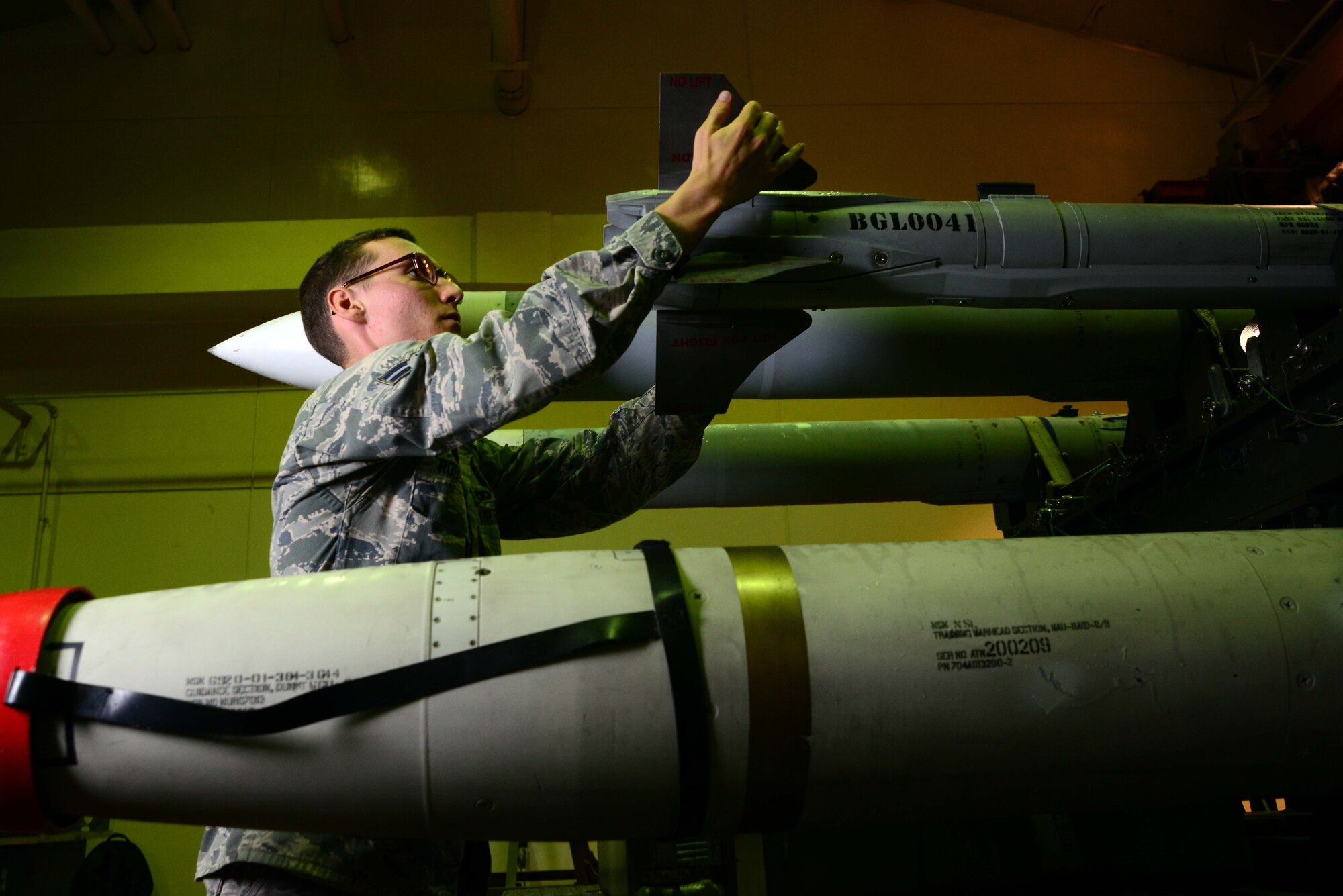 Airman 1st Class Nathan Roberts inspects the tail of an AIM-9X  Sidewinder Missile before delivering it to an F-16 Fighting Falcon June 11, 2014, on Misawa Air Base, Japan. Roberts is an 35th Maintenance Squadron precision guided munitions crew member and has spent two years at Misawa AB delivering munitions to F-16s in support of the Suppression of Enemy Air Defenses mission. (U.S. Air Force photo/Senior Airman Derek VanHorn) 