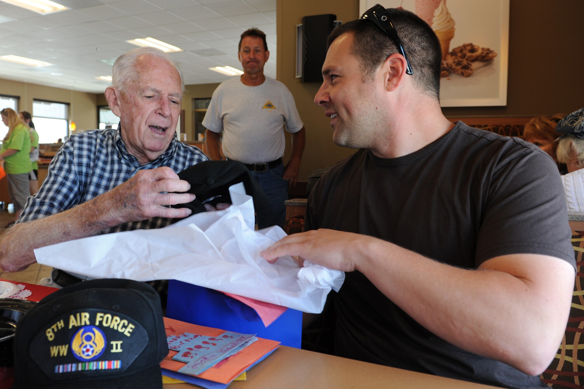 World War II veteran Dale VanBlair, left, receives a gift from Master Sgt. Peter Maraia for his 93rd birthday June 17, 2014, in Belleville, Illinois. VanBlair thanked Maraia for the gift, a hat that displayed B-24 Liberator -- the plane VanBlair served on as a tailgunner during WWII. Maraia is a member of security forces at the Air Mobility Command. (U.S. Air Force photo/Senior Airman Sarah Hall-Kirchner)