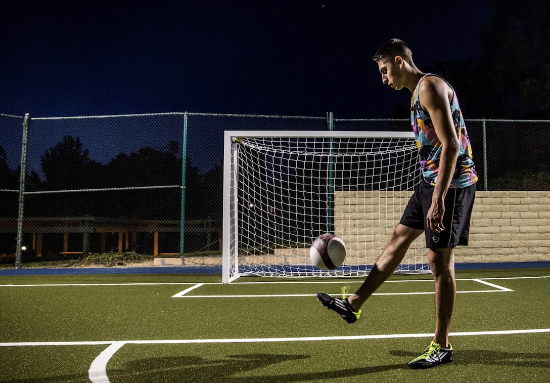 Corporal Rene Gonzalez, data network specialist, 15th Marine Expeditionary Unit, juggles a ball to sharpen his ball handling skills in Oceanside, Calif., July 7, 2014. Gonzalez, 21, is from Joliet, Illinois, and is stationed aboard Camp Pendleton, Calif. (U.S. Marine Corps photo by Cpl. Emmanuel Ramos/Released)