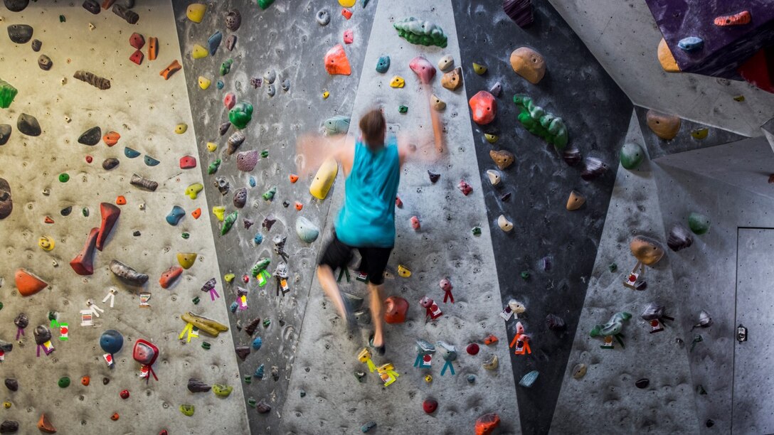 Corporal Tyler Bukoski, computer maintainer, 15th Marine Expeditionary Unit, performs a dynamic movement while making his way to the top of the wall at a rock climbing gym in Carlsbad, Calif., June 27, 2014. Bukoski, 22, is from Wanaque, New Jersey. (U.S. Marine Corps photo by Cpl. Emmanuel Ramos/Released)