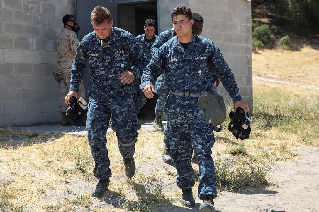A midshipman with 1st Platoon, 2nd Block, Company F, exits the gas chamber during Professional Training for Midshipmen Marine Week aboard Marine Corps Base Camp Pendleton, Calif., July 1, 2014. The PROTRAMID program allows midshipmen to rotate through four week-long evolutions with each different service community in the Navy during their sophomore summer at the Naval Academy. At the beginning of their senior year, they will rank their preferences of which community they'd like to join before being placed based on the needs of the Navy and the Marine Corps. (U.S. Marine Corps photo by Cpl. Anna Albrecht)