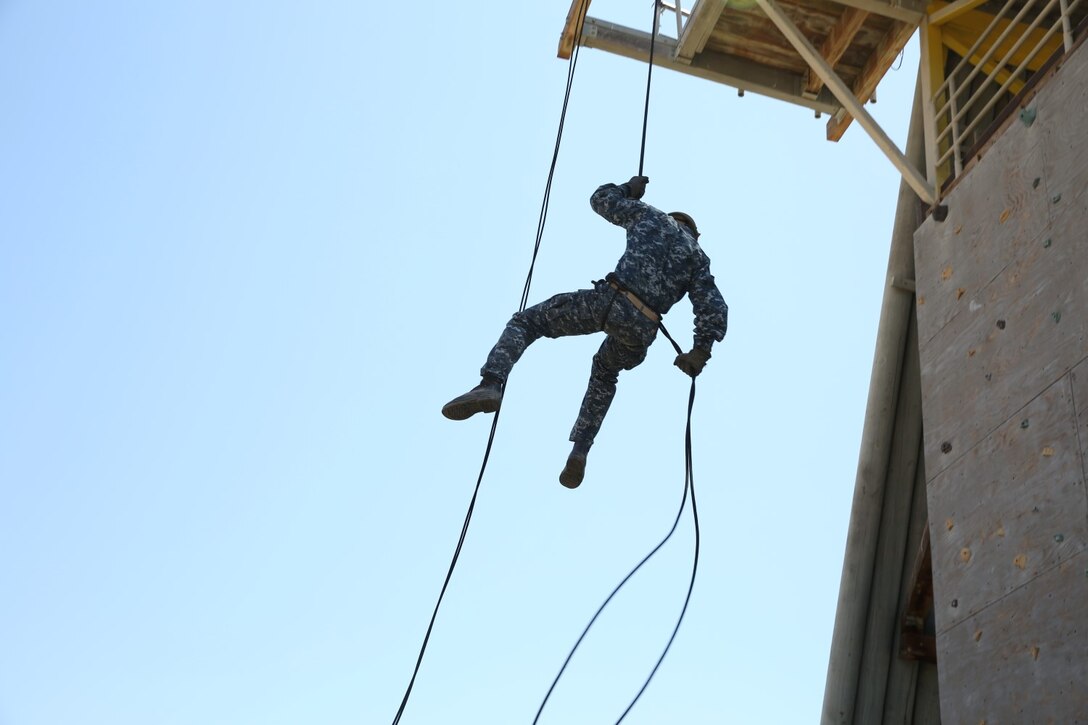 Midshipmen with 1st Platoon, 2nd Block, Company F, rappel during Professional Training for Midshipmen Marine Week aboard Marine Corps Base Camp Pendleton, Calif., July 1, 2014. The PROTRAMID program allows midshipmen to rotate through four week-long evolutions with each different service community in the Navy during their sophomore summer at the Naval Academy. Marine week introduces the midshipmen to Marine Corps culture, history and training. (U.S. Marine Corps photo by Cpl. Anna Albrecht)