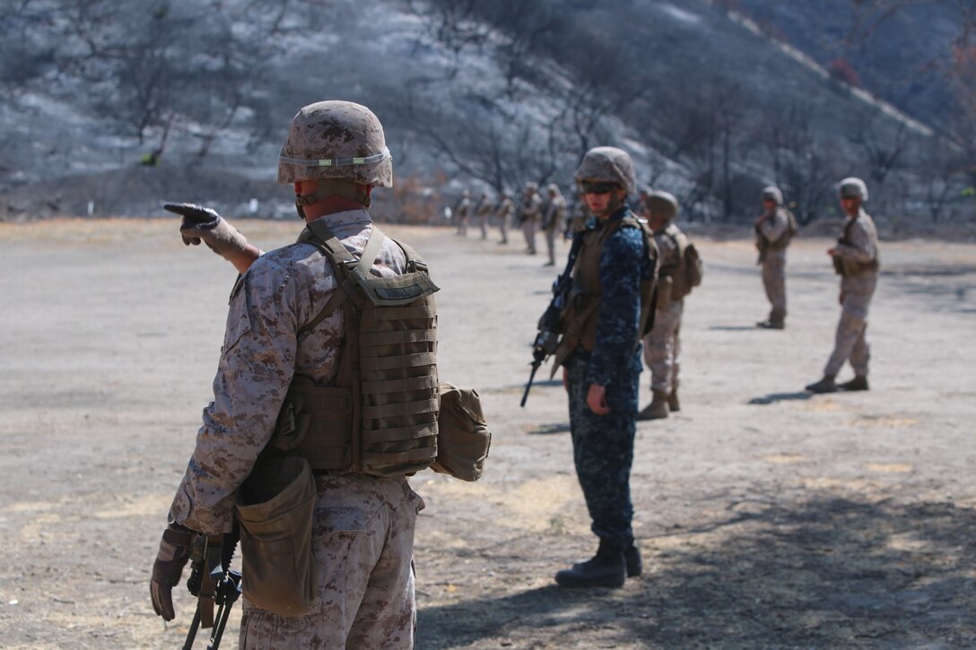 Corporal Keith J. Duvall, 21, from Meridian, Ind., a 1st Squad team leader for Company G, 2nd Battalion, 5th Marine Regiment, gives advice to Midshipman Matt Metzdorff, 20, from Waseca, Minn., a junior at the United States Naval Academy, aboard Marine Corps Base Camp Pendleton Calif., June 30, 2014. Metzdorff is with Company G for a summer internship program where he is shadowing a Marine Corps officer to learn about the paths he could take after he graduates.