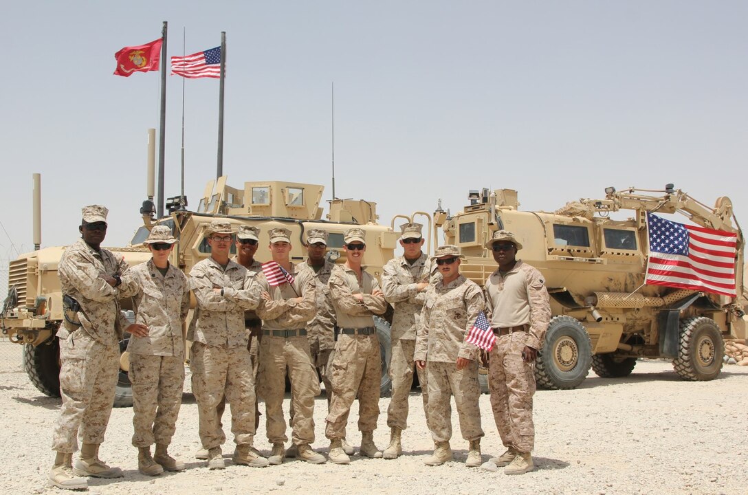 U.S. Marines with Redeployment and Retrograde in support of Reset and Reconstitution Operations Group pose for a photo on the Fourth of July aboard Camp Leatherneck, Helmand province, Afghanistan. U.S. service members throughout Regional Command (Southwest) gathered with their units to honor Independence Day while deployed to Afghanistan, July 4, 2014.