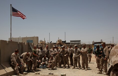 Marines and sailors with the Afghan National Police Advisor Team and Combat Logistics Battalion 7 wait for their final brief to start aboard Patrol Base Dimond, Helmand province, Afghanistan, June 26, 2014. The Marines and sailors of the ANPAT completed their eight-month deployment of advising the Afghan National Police to develop a strong, capable and credible police force for Helmand province. The ANPAT's retrograde back to Camp Leatherneck, Afghanistan, was assisted by the Marines and sailors of Combat Logistics Battalion 7. (U.S. Marine Corps Photo By: Sgt. Frances Johnson)