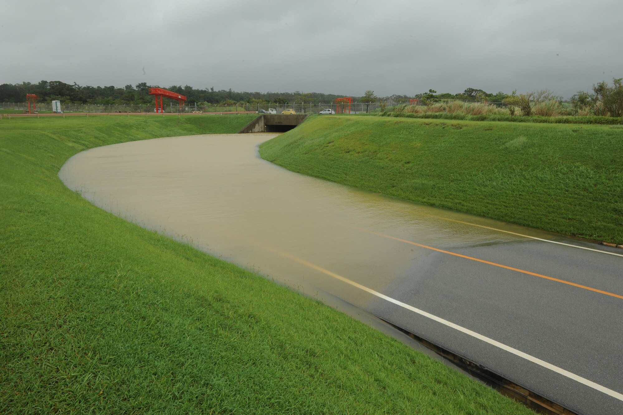 The only road leading to and from the 18th Munitions Squadron flooded in the wake of Typhoon Neoguri on Kadena Air Base, Japan, July 9, 2014. This typhoon was the first one to hit Kadena during the 2014 typhoon season and left many areas flooded and without power. (U.S. Air Force photo by Airman 1st Class Stephen G. Eigel)