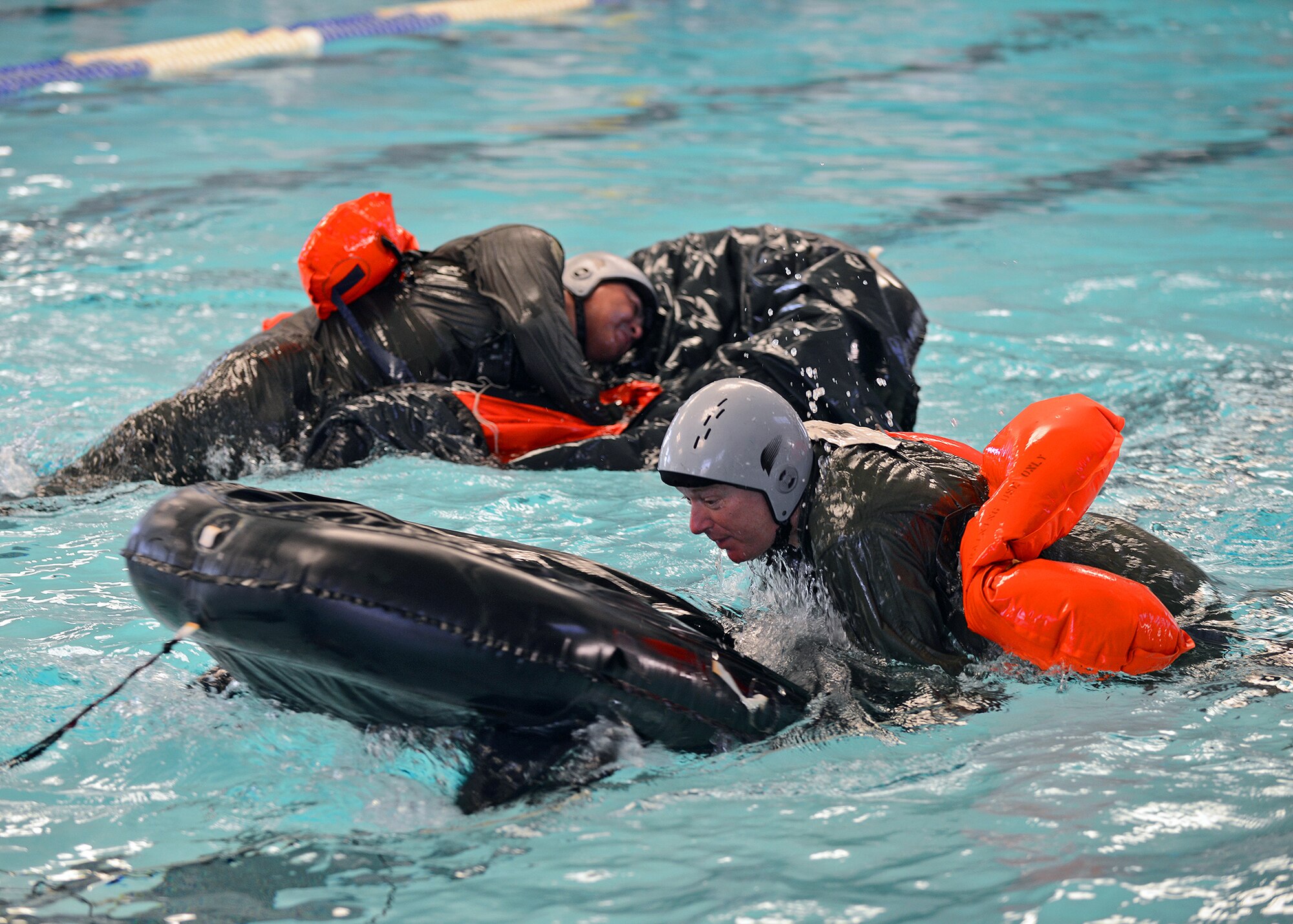Mike Burroughs (front), Broken Bit Steakhouse general manager and 412th Force Support Squadron honorary commander, was one of three honorary commanders that participated July 2 in a land and water survival training class taught by Edwards Survival, Evasion, Resistance, and Escape instructors at the Oasis Aquatic Center. The primary objective of the Honorary Commanders Program is to familiarize community leaders with Edwards' operations by pairing them with unit commanders and directors at both social and official functions. This program is an avenue for community partner leaders to learn about the Air Force mission, personnel, programs and operations. (U.S. Air Force photo by Jet Fabara)