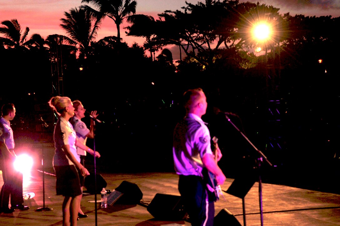 WAIKOLOA, Hawaii – Members of the “Hana Hou!”, Band of the Pacific-Hawaii, performs for the people of Waikoloa as the sun cascades an array of beautiful colors over the Hawaii skyline. The band performed for thousands at the annual Waikoloa Bowl “Family Fourth and Fireworks” celebration. “Hana Hou!” played a patriotic closer, which was synced up to the ornate fireworks display. After the patriotic closer, the audience was chanting “U.S.A”! (US Air Force Photo/ TSgt Michael Smith/released)