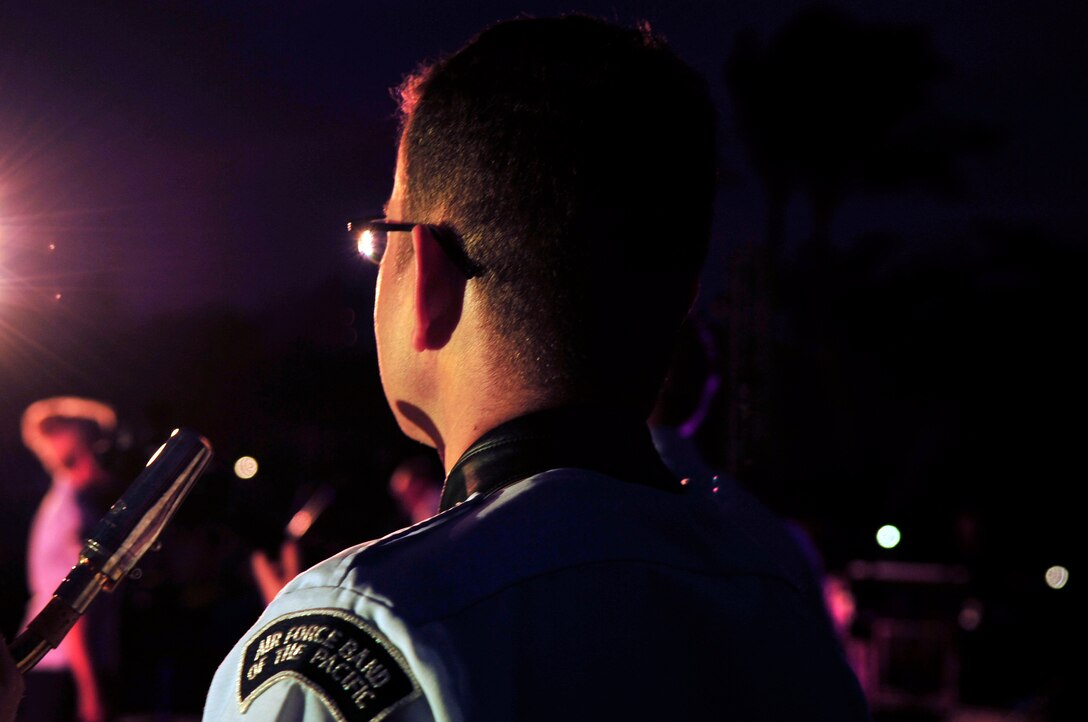 WAIKOLOA, Hawaii – TSgt Miles Hudlow (saxophone), Band of the Pacific-Hawaii, enjoys the spot light at the annual Waikoloa Bowl “Family Fourth and Fireworks” celebration. “Hana Hou!” played a patriotic closer, which was synced up to an ornate fireworks display. After the patriotic closer, the audience was chanting “U.S.A”!  (US Air Force Photo/ SSgt Courtney Clifford/released)