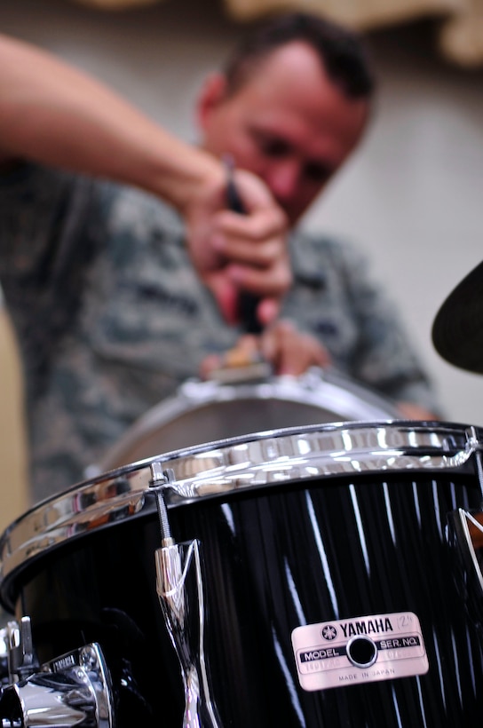 JOINT BASE PEARL HARBOR-HICKAM, Hawaii – TSgt(S) Troy Griffin, Band of the Pacific-Hawaii, repairs his snare drum before rehearsal, July 2, 2014. TSgt(S) Troy Griffin is the newly appointed Non-commissioned Officer in Charge (NCOIC) of the rock band, “Hana Hou!”. (U.S. Air Force Photo/ SSgt. Courtney Clifford/released)