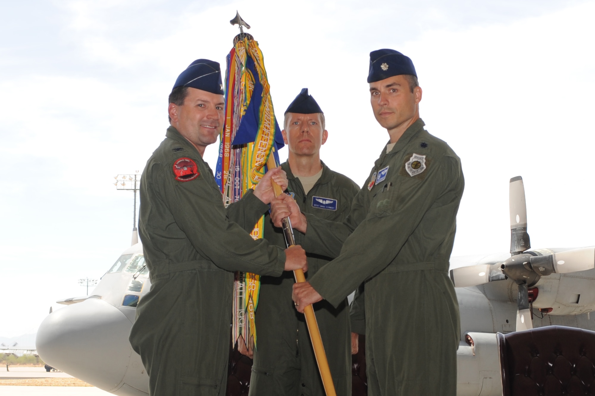 U.S Air Force Col. George Reynolds, 55th Electronic Combat Group commander, hands off the responsibility of the 42nd Electronic Combat Squadron to Lt. Col. Karl Weinbrecht during a Change of Command Ceremony at Davis-Monthan Air Force base, Ariz., July 9, 2014. The Change of Command Ceremony is a military tradition that symbolizes the passing of command so all may witness the changing of leadership responsibilities. (U.S. Air Force photo by Airman 1st Class Cheyenne Morigeau/Released)
