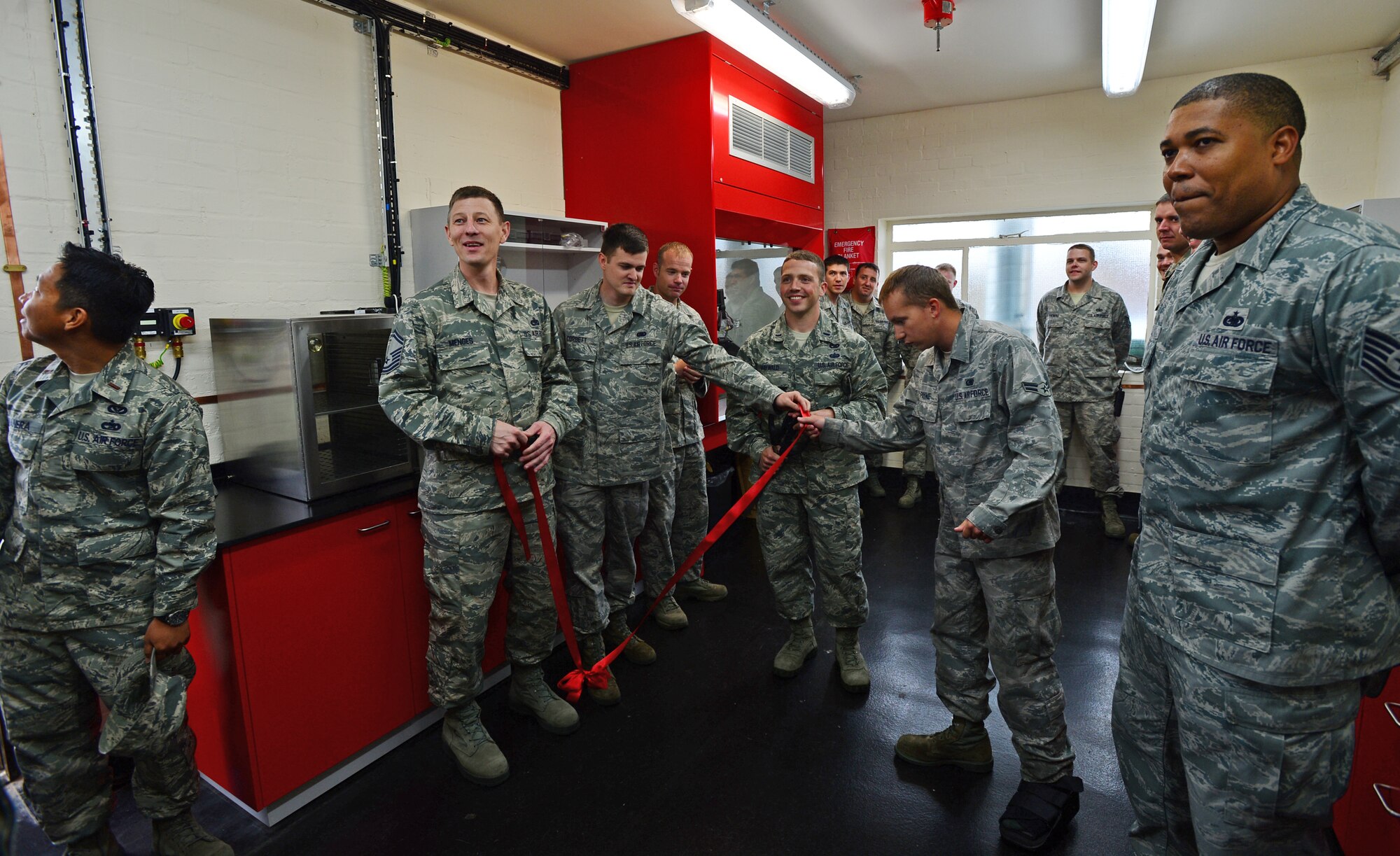 Airmen from the 48th Logistics Readiness Squadron fuels management flight prepare for a ribbon-cutting ceremony in their newly-renovated laboratory at Royal Air Force Lakenheath, England, June 27, 2014. The 48th Civil Engineer Squadron coordinated with the 48th LRS to complete a two-year-long laboratory project that allows the FMF to analyze the installations ground and aviation fuel at a fraction of the time and cost. (U.S. Air Force photo by Airman 1st Class Erin O’Shea/Released) 