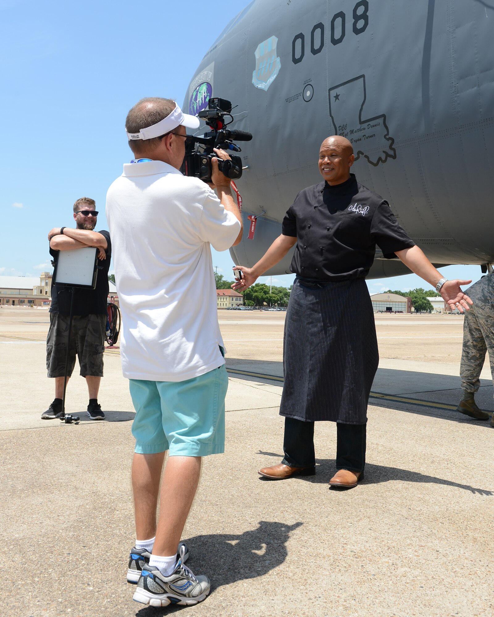 Chef Jeff Henderson, Flip My Food host, gives an interview in front of a B-52H Stratofortress during a filming of Flip My Food on Barksdale Air Force Base, La., July 9, 2014. Henderson is an award-winning chef and best-selling author who has been featured on many cooking television programs. (U.S. Air Force photo/Senior Airman Benjamin Gonsier) 