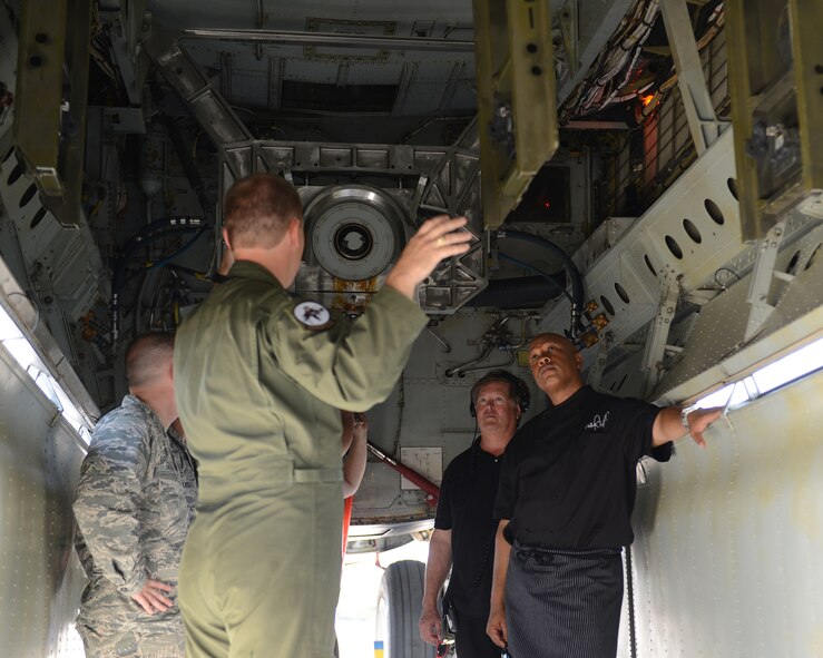 Capt. Matthew Middlebrooks, left, 11th Bomb Squadron, explains the bomb bay of a B-52H Stratofortress to Chef Jeff Henderson, Flip My Food host, on Barksdale Air Force Base, La., July 9, 2014. Henderson received a tour of a B-52 during his visit of Barksdale, where he cooked healthy dishes, like salad and soup, for Airmen. (U.S. Air Force photo/Senior Airman Benjamin Gonsier)