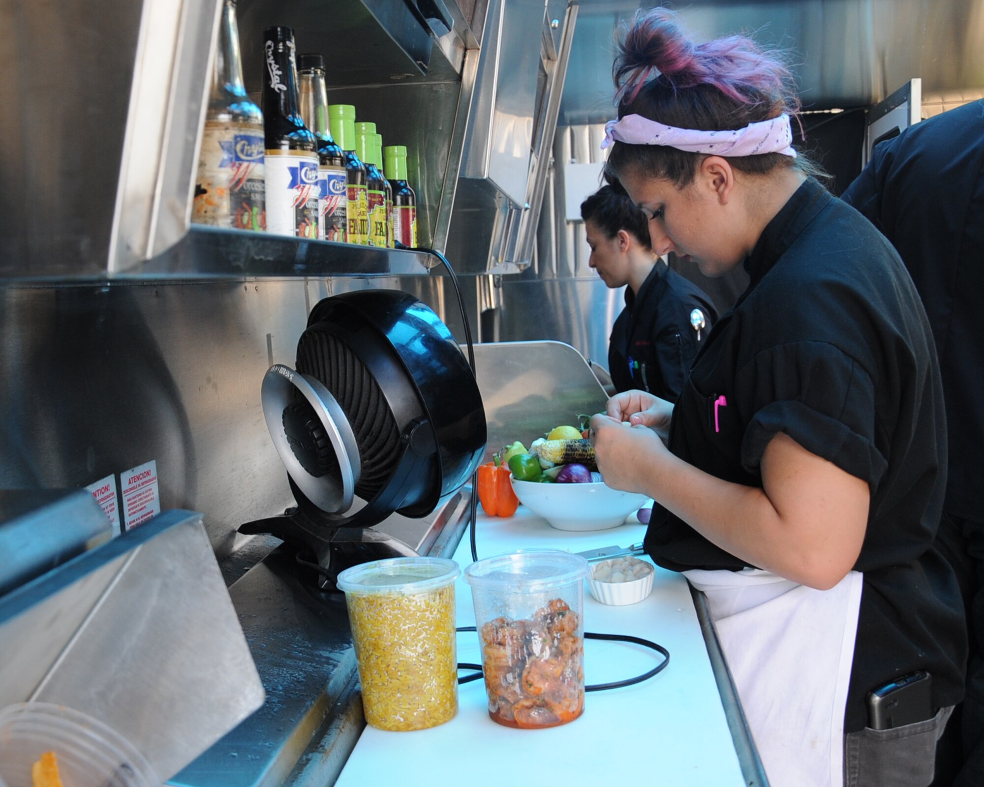 Sarah Chatagnier, assistant sous chef, prepares food during a taping of Flip My Food on Barksdale Air Force Base, La., July 9, 2014. Flip My Food came to Barksdale to promote a healthy way of eating to Airmen.  (U.S. Air Force photo/Staff Sgt. Sean Martin)

