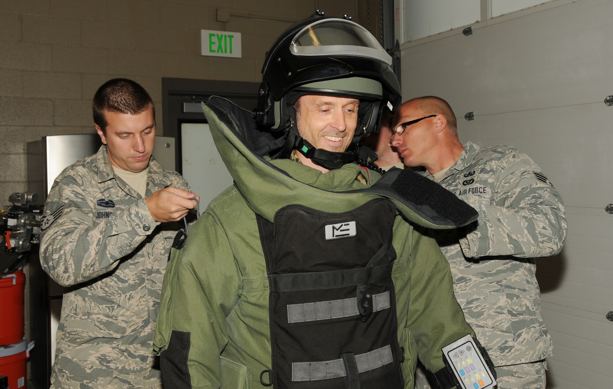 Staff Sgt. Chris Johnson (left) and Senior Airman Chris Cunningham (right), explosive ordnance disposal technicians with the 151st Civil Engineering Squadron, put a bomb suit on Lt. Col. Timo Diegmueller during his tour of the Utah Air National Guard EOD unit. Diegmueller, a Reserve intelligence officer with the German Air Force, visited the Air Guard Base in Salt Lake City while participating in the Department of Defense Reserve Officers Foreign Exchange Program. (Utah Air National Guard Photo by Staff Sgt. Annie Edwards/RELEASED)