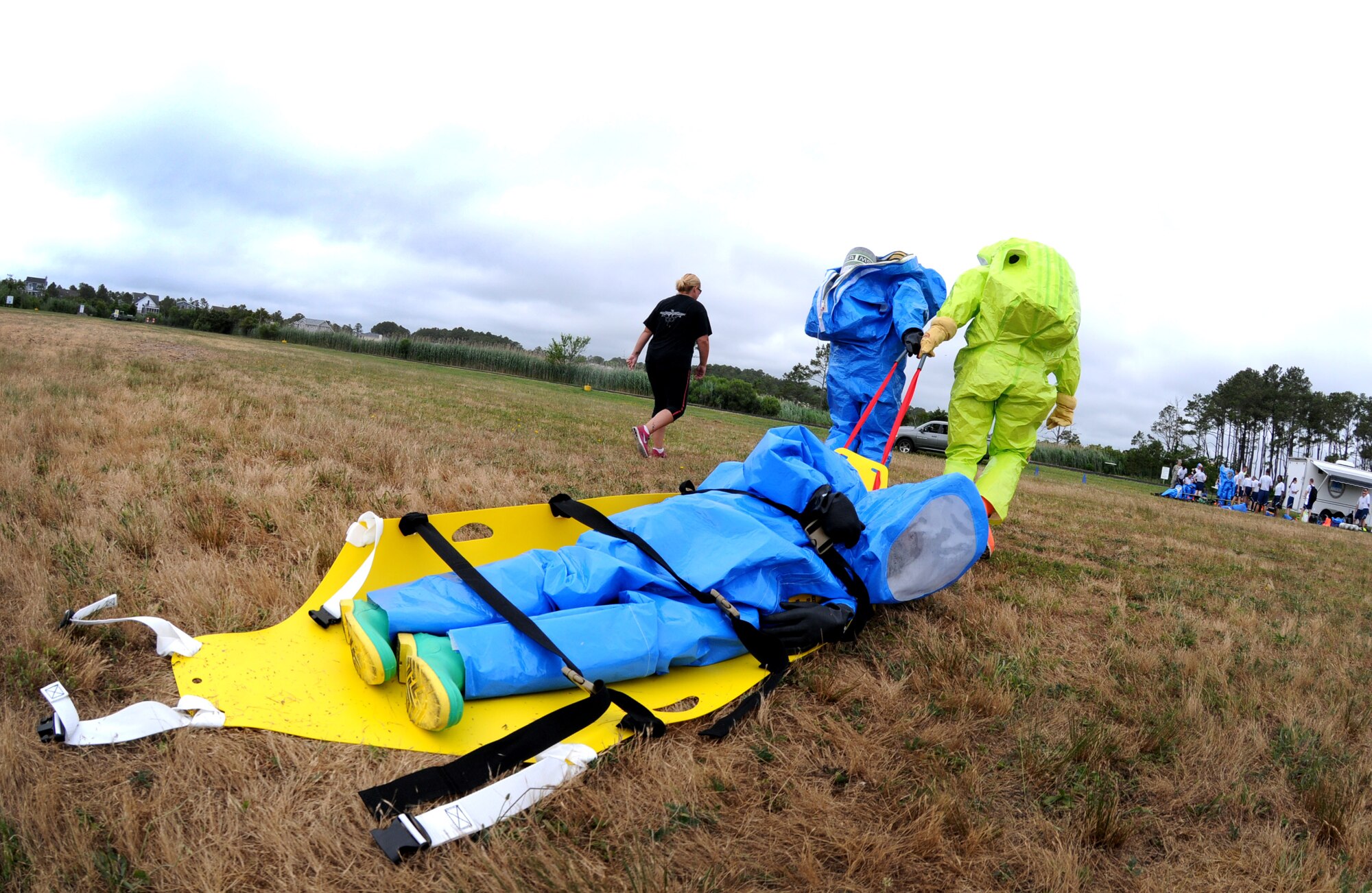 Emergency Management specialists transport a fellow EM specialist to 'safety' while simulating an evacuation of personnel during the Region 3 Emergency Management training exercise at the Bethany Beach Regional Training Institute, Delaware Air National Guard June 27, 2014. More than 40 emergency managers comprised from the District of Columbia, Delaware, Maryland, and Pennsylvania Air National Guard participated in the inaugural Region 3 training exercise. (Air National Guard photo by Master Sgt. Craig Clapper/Released) 