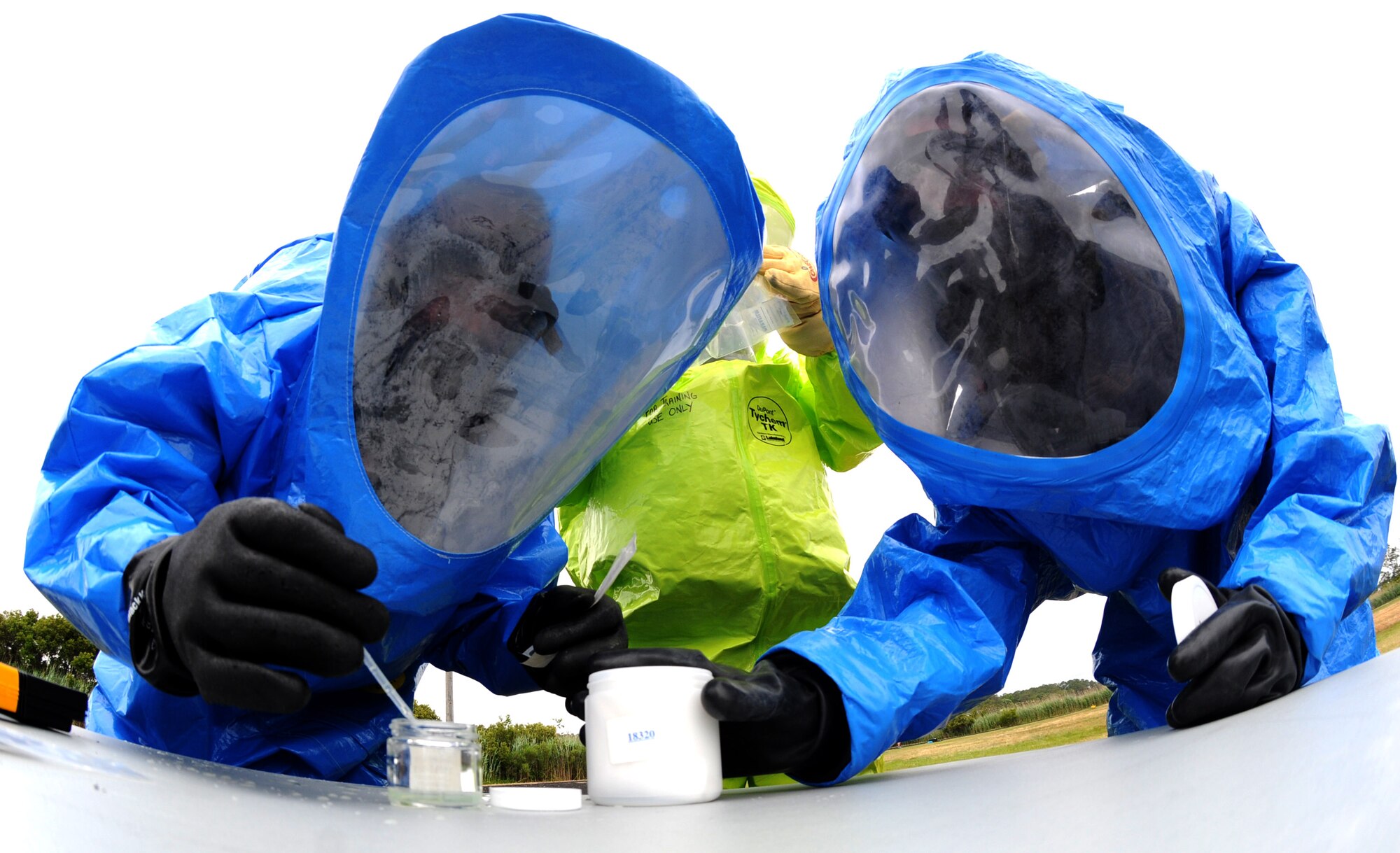 Emergency Managers, donned in hazardous materials suits take a sample of an unknown chemical during the Region 3 Emergency Management training exercise at the Bethany Beach Regional Training Institute, Delaware Air National Guard June 27, 2014. More than 40 emergency managers comprised from the District of Columbia, Delaware, Maryland, and Pennsylvania Air National Guard participated in the inaugural Region 3 training exercise. (Air National Guard photo by Master Sgt. Craig Clapper/Released)