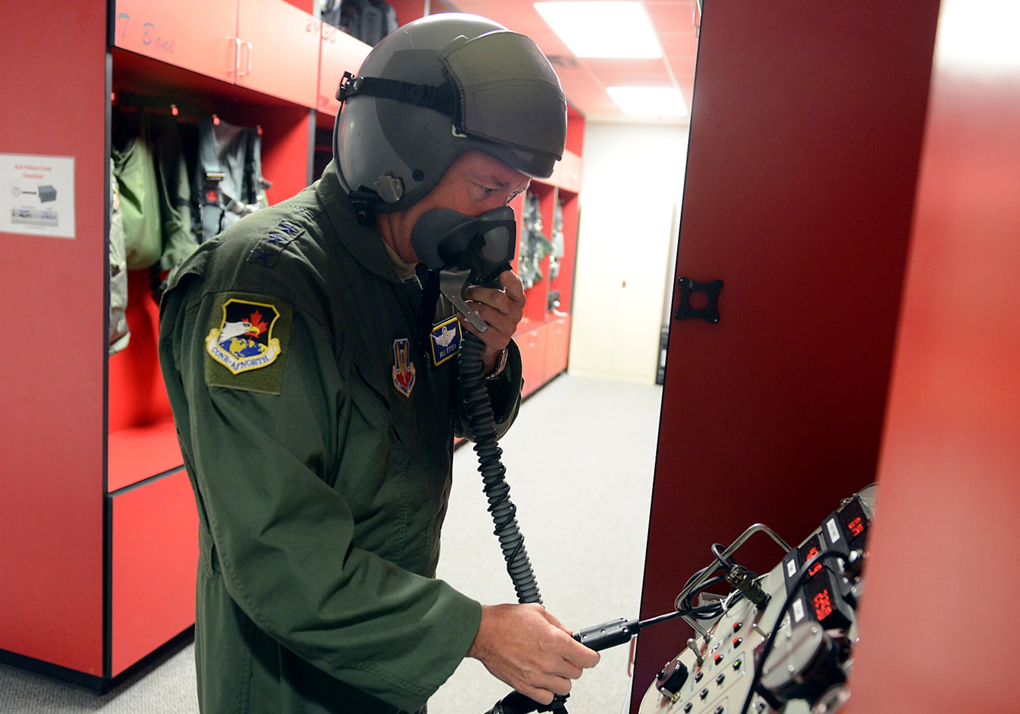 First Air Force Commander, Lt Gen William Etter, conducts a pre-flight equipment check during a visit at the 138th Fighter Wing in Tulsa Okla., 24 June 2014. Etter stopped at the 138th for a brief visit and to fly a training mission with the F-16 pilots of the 125th Fighter Squadron. (U.S. National Guard photo by Senior Master Sgt. Preston L. Chasteen/Released)