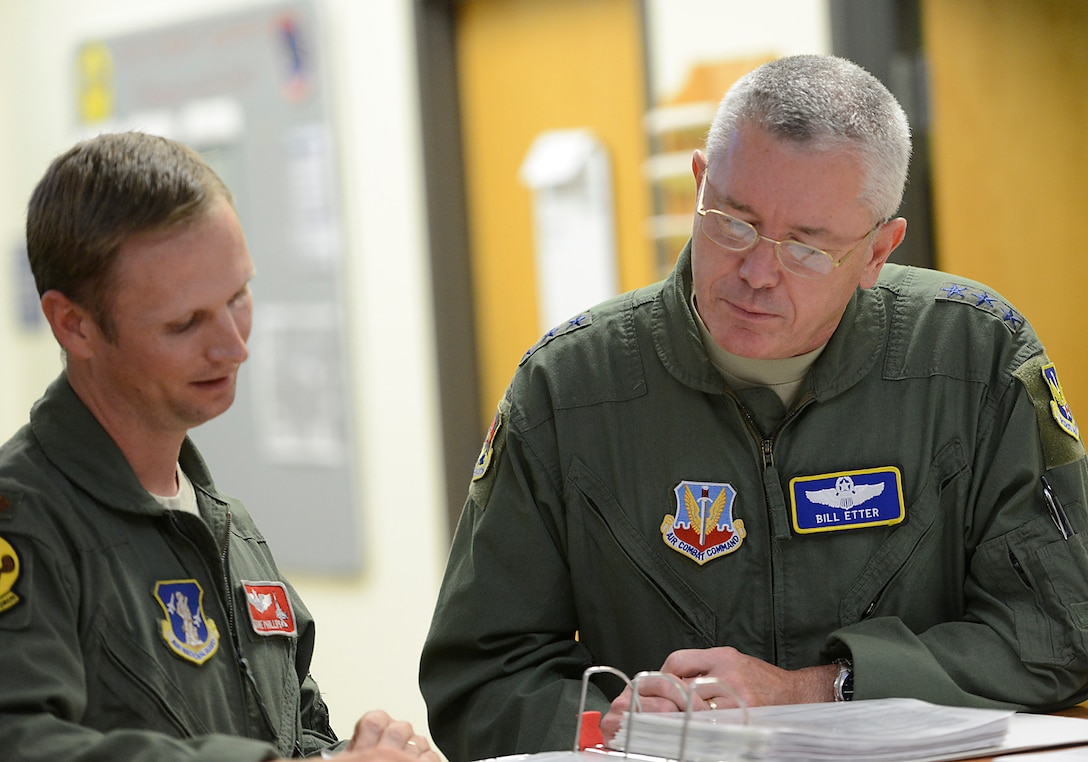 First Air Force Commander, Lt Gen William Etter, is given a pre-flight brief by Major David Phillips, 138th Operation Group, 24 June 2014. Etter stopped at the 138th for a brief visit and to fly a training mission with the F-16 pilots of the 125th Fighter Squadron. (U.S. National Guard photo by Senior Master Sgt. Preston L. Chasteen/Released)