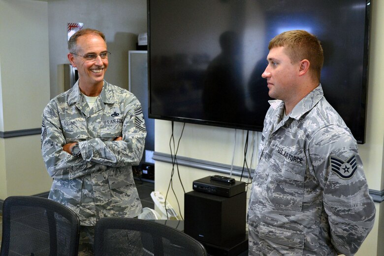 Chief Master Sgt. Pete Stone, U.S. Air Force Expeditionary Center command chief, discusses enlisted issues with Staff Sgt. Jonathan Pesek, 43rd Aircraft Maintenance Squadron, during his tour of 43rd Airlift Group units on July 8, 2014, Pope Army Airfield, N.C. (U.S. Air Force photo/Marvin Krause)