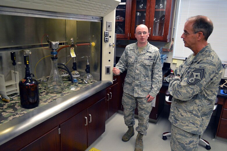 Staff Sgt. Jonathan Boggs, 43rd Logistics Readiness Squadron, briefs fuels laboratory operations to Chief Master Sgt. Pete Stone, U.S. Air Force Expeditionary Center command chief, during his tour of 43rd Airlift Group units on July 8, 2014, Pope Army Airfield, N.C. (U.S. Air Force photo/Marvin Krause)