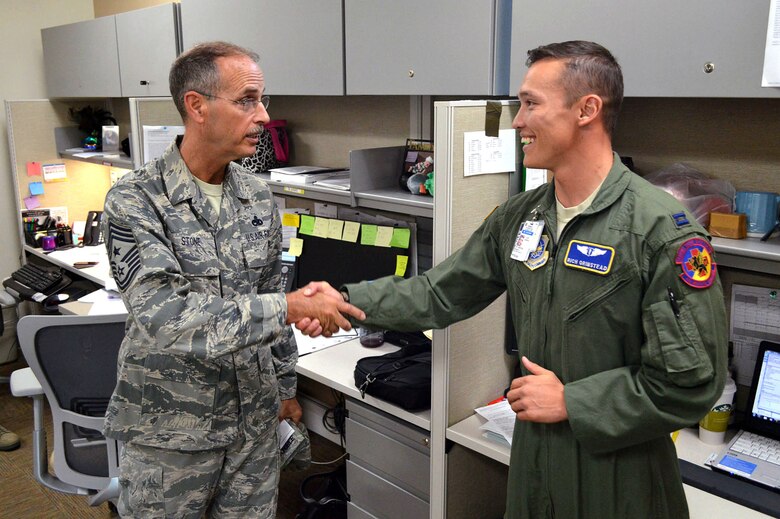 Chief Master Sgt. Pete Stone, U.S. Air Force Expeditionary Center command chief, shakes hands with  Capt. Richard Grinstead, 43rd Medical Squadron, during his tour of 43rd Airlift Group units on July 8, 2014, Pope Army Airfield, N.C. (U.S. Air Force photo/Marvin Krause)