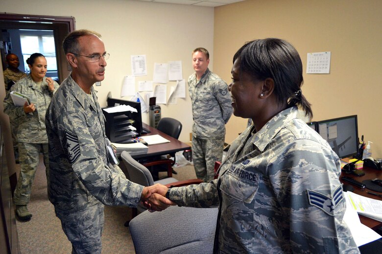 Chief Master Sgt. Pete Stone, U.S. Air Force Expeditionary Center command chief, shakes hands with Senior Airman Jasmine Brown, 43rd Force Support Squadron, during his tour of 43rd Airlift Group units on July 8, 2014, Pope Army Airfield, N.C. (U.S. Air Force photo/Marvin Krause)