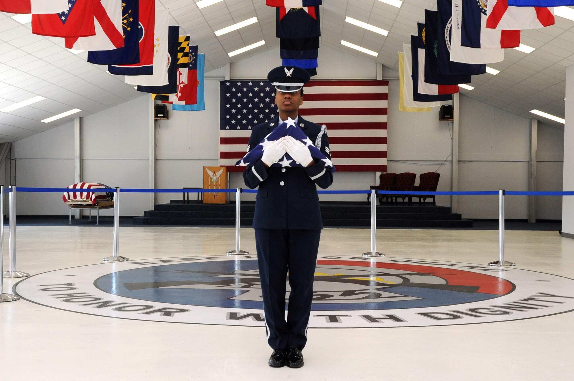 Senior Airman Tralisha Russell, Grand Forks Air Force Base Honor Guard ceremonial guardsman, poses with the American flag in the base honor guard building July 9, 2014, on Grand Forks Air Force Base, N.D. The Omaha, Neb., native was named Warrior of the Week for the second week of July, 2014. (U.S. Air Force photo by Staff Sgt. David Dobrydney)