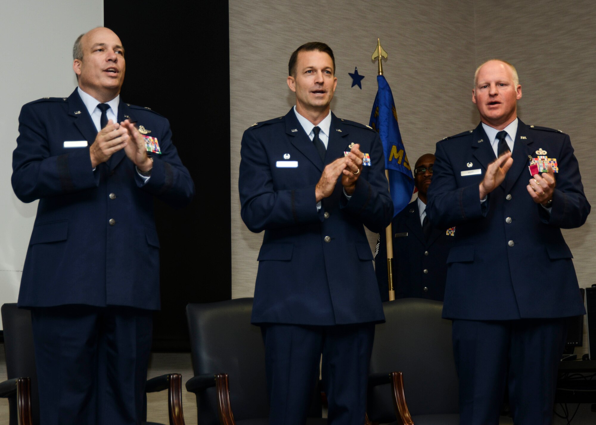 Brig. Gen. Michael Brewer (left), 412th Test Wing commander, Lt. Col. Eric Leshinsky (middle), incoming 412th Mission Support Group commander, and Col. Robert Hoff outgoing 412th MSG commander, join in singing the Air Force Song at the conclusion of the change of command ceremony July 9. (U.S. Air Force photo by Rebecca Amber) 