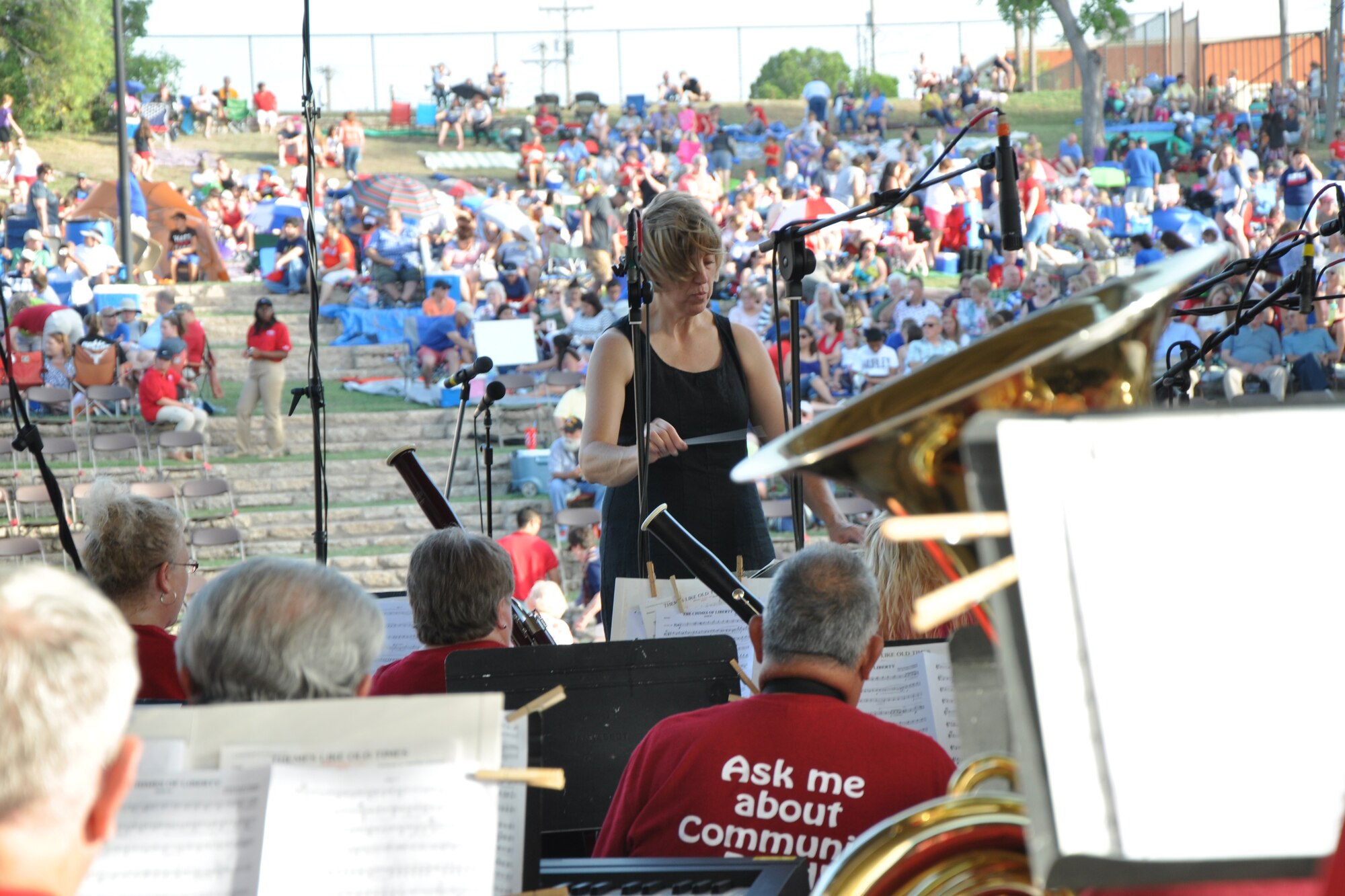 SAN ANGELO, Texas – Constance L. Kelley, San Angelo Community Band Director, conducts the San Angelo Community Band for the Annual Pops Concert at the Bill Aylor Sr. Memorial RiverStage here July 3. The band played several songs before the San Angelo Symphony Orchestra performed their concert. (U.S. Air Force photo/ Senior Airman Joshua Edwards)