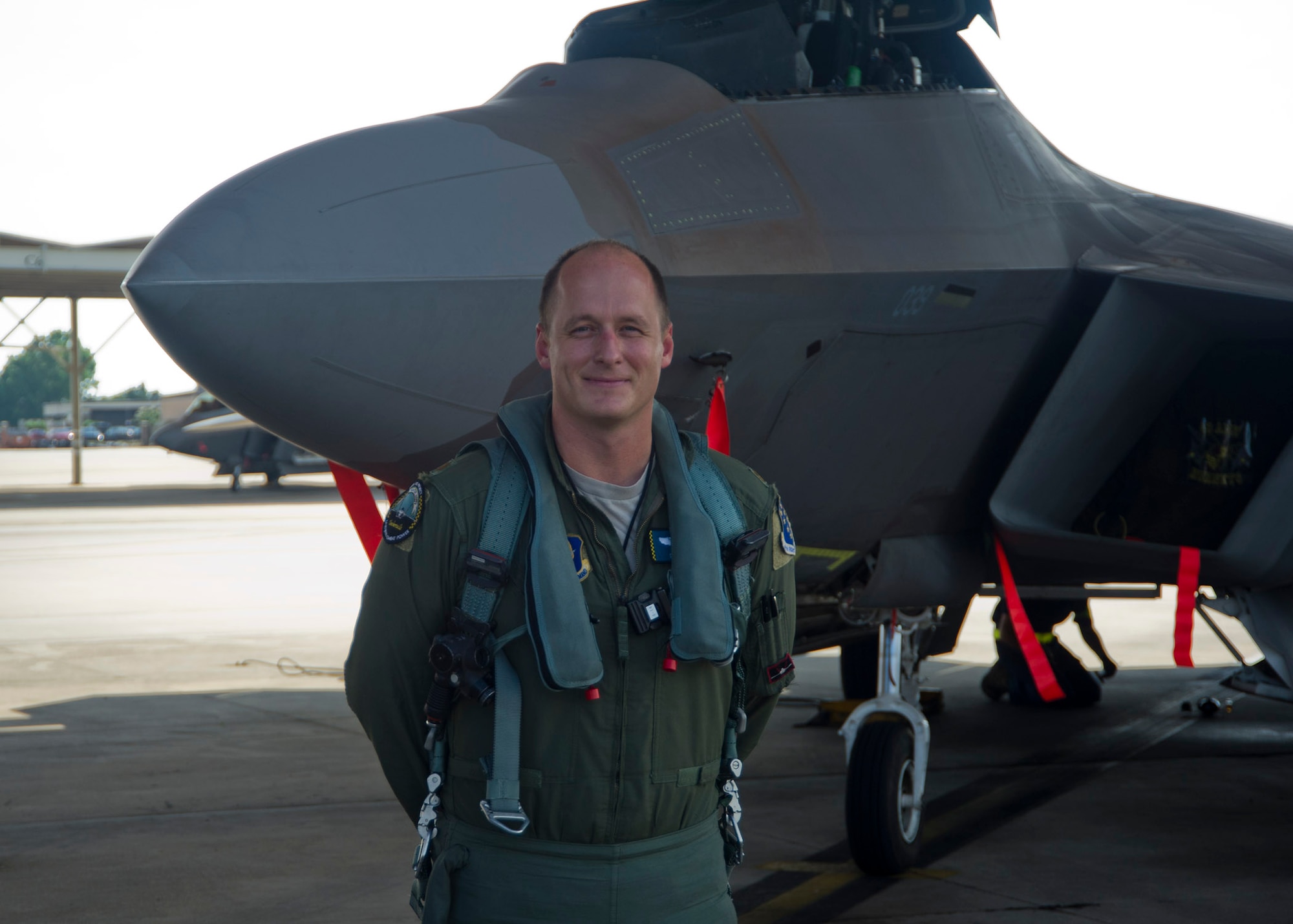 Major Daniel “Magic” Lee, 43rd Fighter Squadron instructor pilot, stands in front of the F-22 Raptor, which he reached his 1,000th hour of flight time in, on July 8. He is currently only the fifth person in Air Force history to achieve this milestone. (U.S. Air Force photo by Airman 1st Class Dustin Mullen)