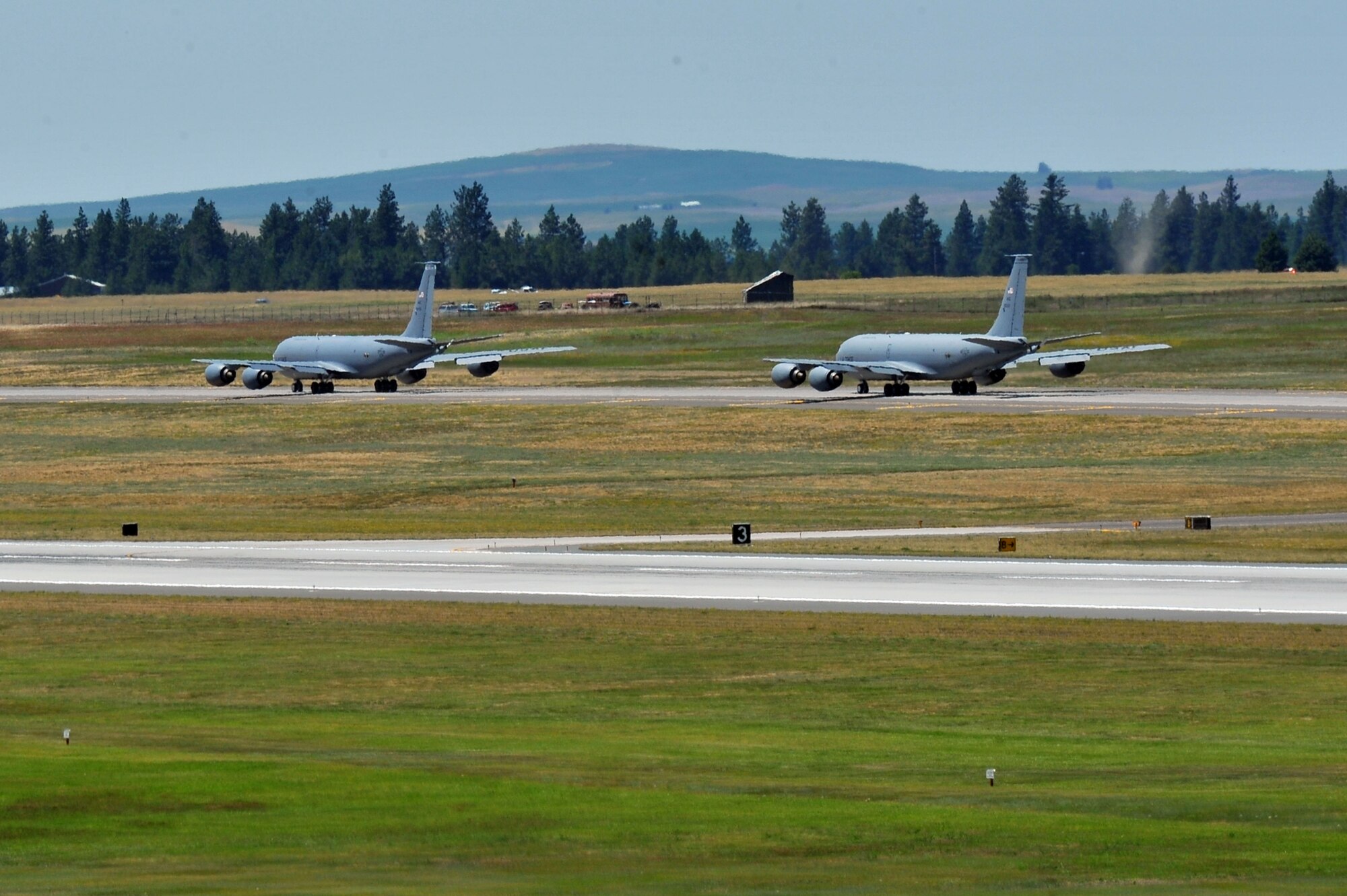 Members from the 509th Weapons Squadron taxi along the runway on KC-135 Stratotankers to execute minimum interval takeoff procedures for the first time in twenty years reduced July 8, 2014 at Fairchild Air Force Base, Wash.  The 509th WPS mission is to provide the world's most advanced training in weapons and tactics employment to officers of the Air Force. (U.S. Air Force photo by Staff Sgt. Veronica Montes/Released)