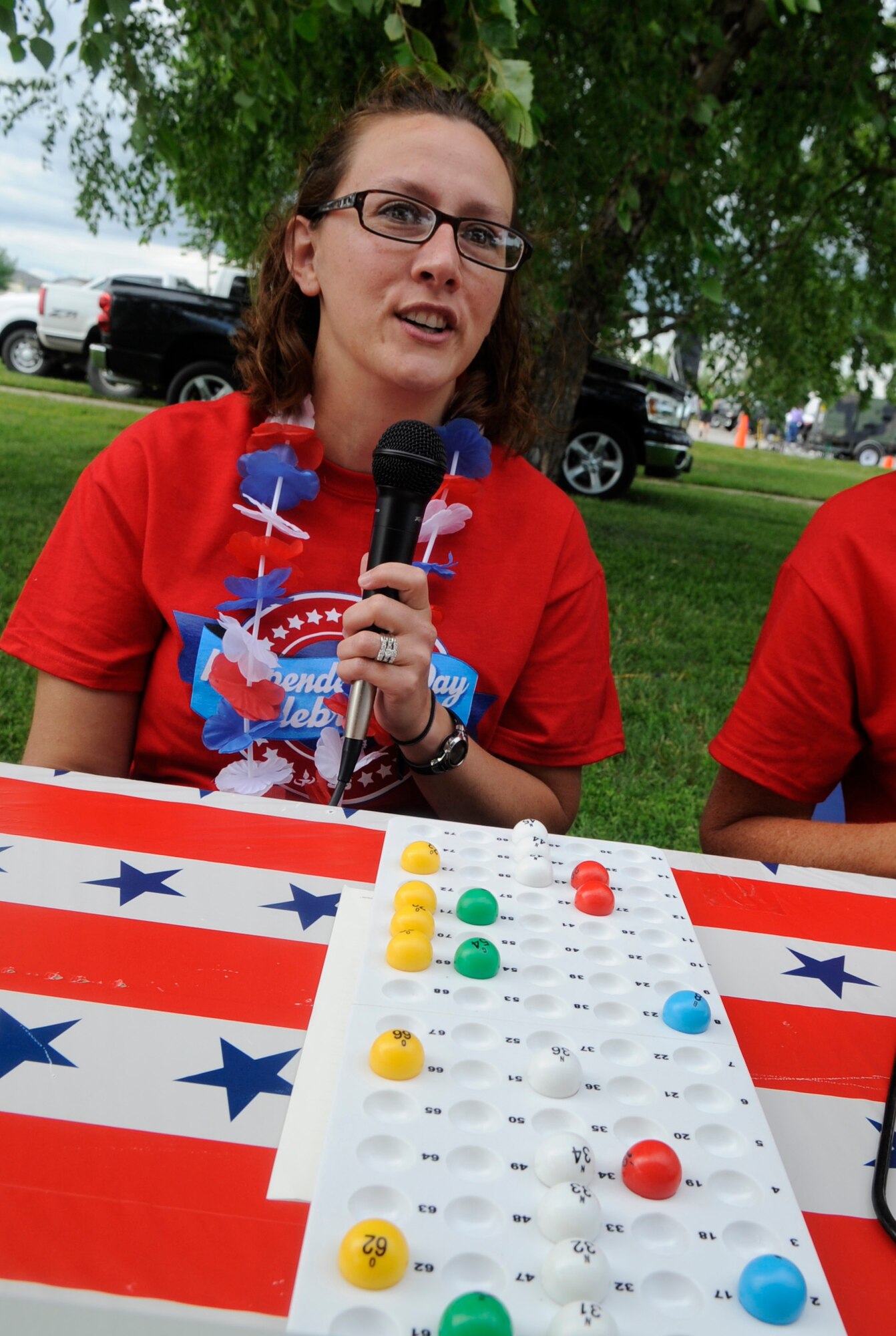 Tiffany Bell announces the bingo numbers during the Independence Day Celebration at Whiteman Air Force Base, Mo., July 2, 2014. Bingo was only one of the several family activities which were provided before the fireworks. Tiffany is the wife of Chief Master Sgt. Robert Bell, 509th Force Support Squadron superintendent. (U.S. Air Force photo by Staff Sgt. Alexandra M. Boutte/Released)