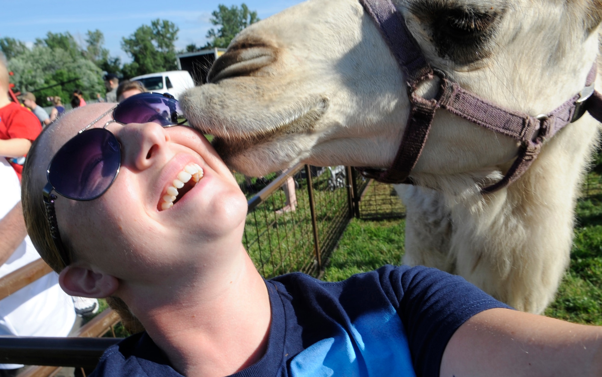 Staff Sgt. Alexandra M. Boutte, 509th Bomb Wing Public Affairs photojournalist, takes a selfie with a camel during the Independence Day Celebration at Whiteman Air Force Base, Mo., July 2, 2014. The celebration provided food, drinks, petting zoo, fishing derby, bouncy playhouses, water slide and carnival rides. (U.S. Air Force photo by Staff Sgt. Alexandra M. Boutte/Released)