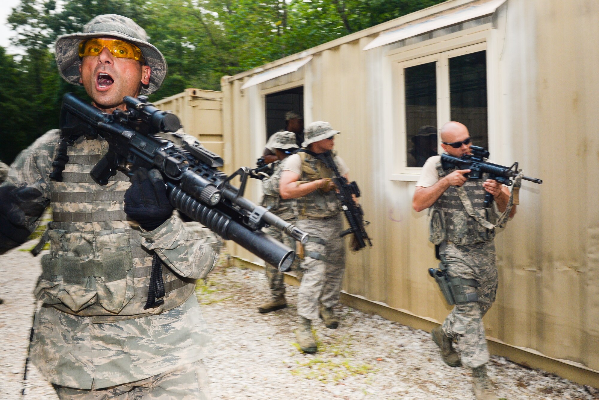 U.S. Airmen from the 116th Security Forces Squadron (SFS), Georgia Air National Guard, take part in counterinsurgency operations, or COIN, training at the Catoosa Training Site, Tunnel Hill, Ga., June 29, 2014. The 116th SFS deployed to the Catoosa Training Site for annual training where they received extensive classroom and hands-on training to hone their skills on various firearms such as the M4 carbine, M203 grenade launcher and M240 and M249 machine guns as well as training in various security operations performed by Air Force security forces personnel. During COIN training, the Security Forces Airmen used a simulated local village to practice building breaching and clearing operations as well as working with the local populace while encountering simulated threats. (U.S. Air National Guard photo by Master Sgt. Roger Parsons/Released)