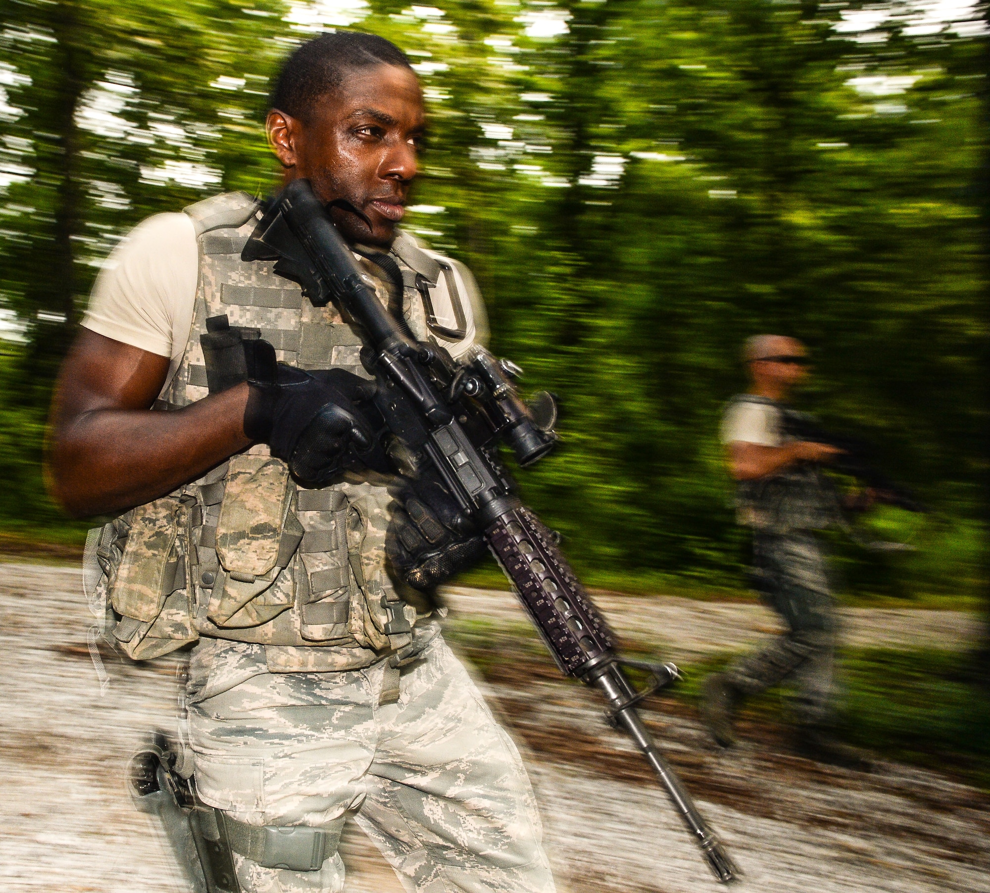 U.S. Air Force Senior Airman Fitzgerald Wiggleton, a member of the 116th Security Forces Squadron (SFS), Georgia Air National Guard, takes part in counterinsurgency operations, or COIN, training at the Catoosa Training Site, Tunnel Hill, Ga., June 29, 2014. The 116th SFS deployed to the Catoosa Training Site for annual training where they received extensive classroom and hands-on training to hone their skills on various firearms such as the M4 carbine, M203 grenade launcher and M240 and M249 machine guns as well as training in various security operations performed by Air Force security forces personnel. During COIN training, the Security Forces Airmen used a simulated local village to practice building breaching and clearing operations as well as working with the local populace while encountering simulated threats. (U.S. Air National Guard photo by Master Sgt. Roger Parsons/Released)