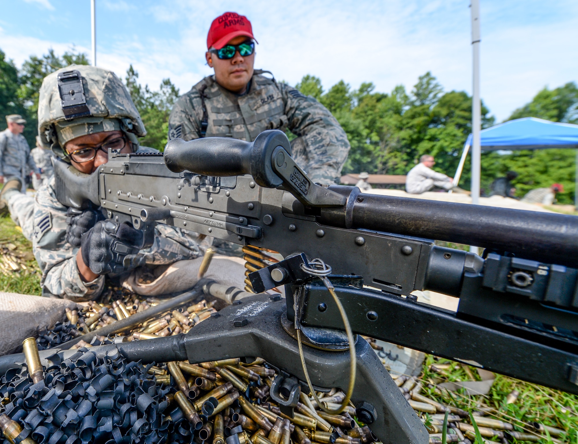 U.S. Air Force Senior Airman Quataisia Marigny, a member of the 116th Security Forces Squadron (SFS), Georgia Air National Guard, fires an M240 machine gun under the watchful eye of Staff Sgt. Alan Glaze, a combat arms instructor from the 116th SFS, during a training exercise at the Catoosa Training Site, Tunnel Hill, Ga., June 26, 2014. The 116th SFS is the security arm of the 116th Air Control Wing based at Robins Air Force Base, Ga. The squadron deployed to the Catoosa Training Site for annual training where they received extensive classroom and hands-on training to hone their skills on various firearms such as the M4 carbine, M203 grenade launcher and M240 and M249 machine guns. (U.S. Air National Guard photo by Master Sgt. Roger Parsons/Released)