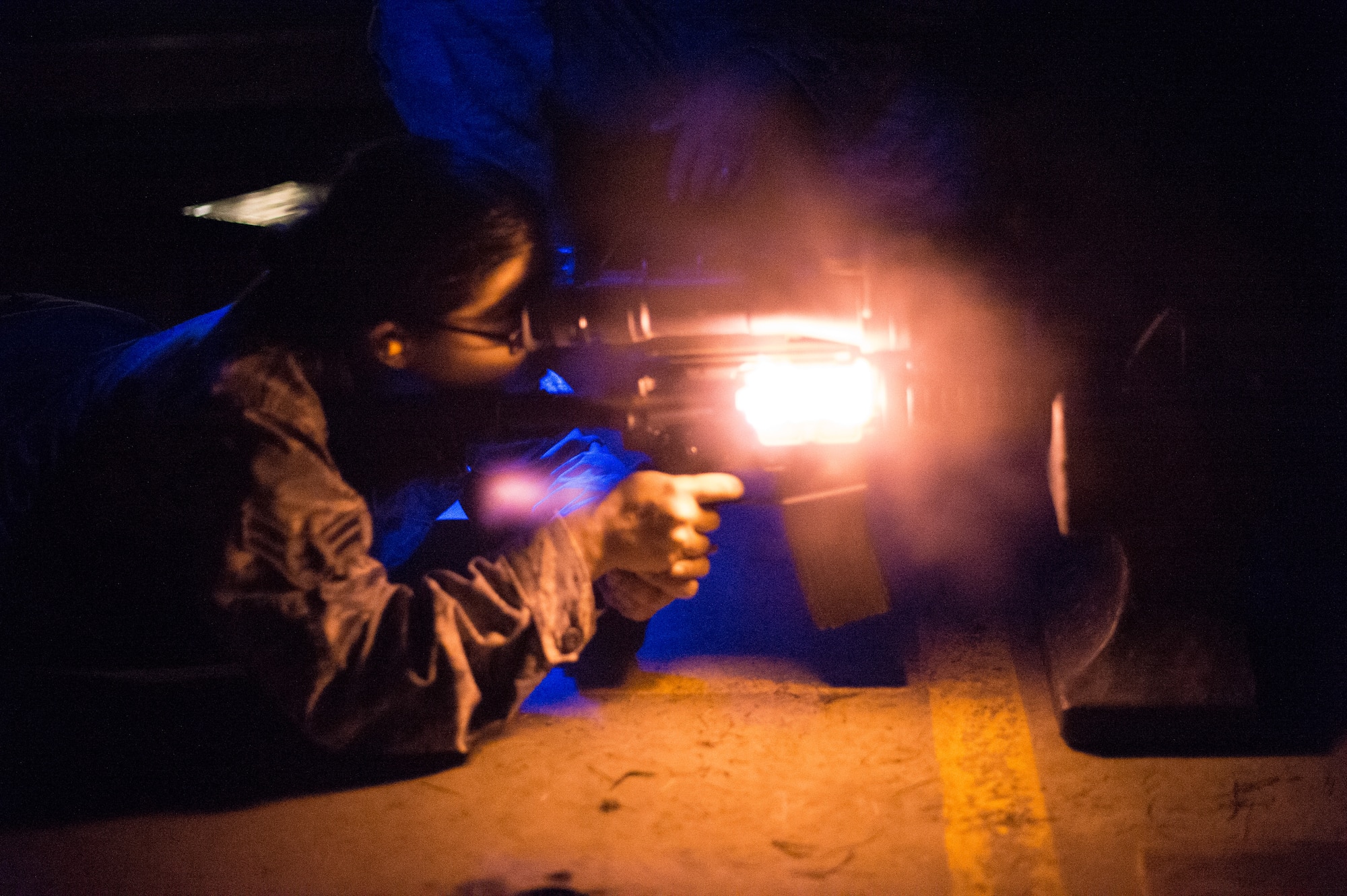U.S. Air Force Airman 1st Class Paula Helms, a member of the 116th Security Forces Squadron (SFS), Georgia Air National Guard, fires an M4 carbine rifle during a night time training exercise at the Catoosa Training Site, Tunnel Hill, Ga., June 25, 2014. The 116th SFS is the security arm of the 116th Air Control Wing based at Robins Air Force Base, Ga. The squadron deployed to the Catoosa Training Site for annual training where they received extensive classroom and hands-on training to hone their skills on various firearms such as the M4 carbine, M203 grenade launcher and M240 and M249 machine guns. (U.S. Air National Guard photo by Master Sgt. Roger Parsons/Released)