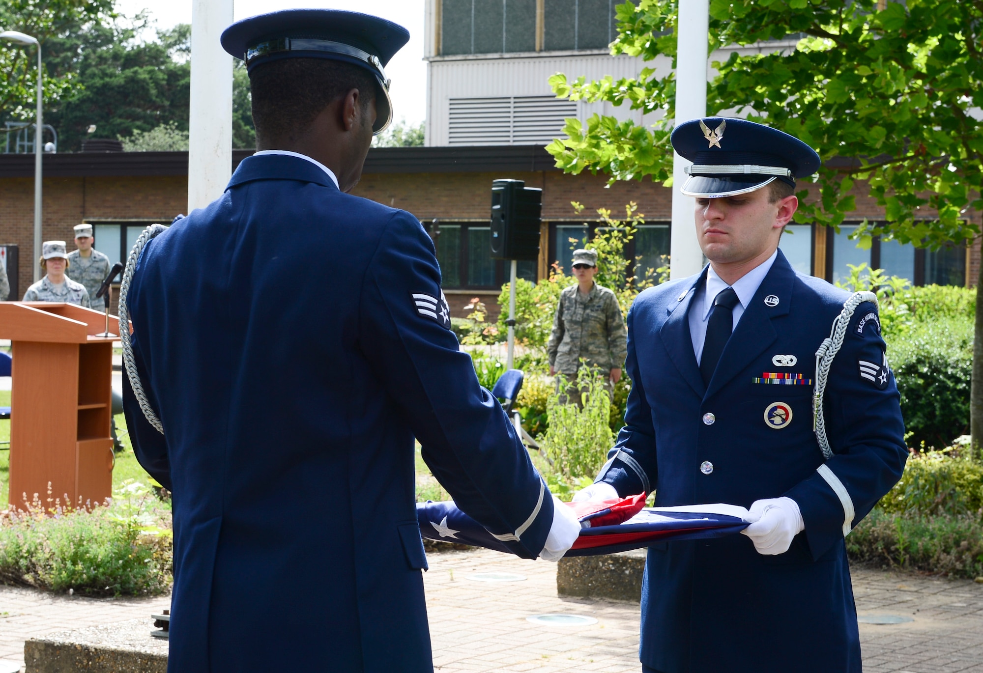 Members of the 48th Fighter Wing Honor Guard fold the American flag after the playing of Colors at Royal Air Force Lakenheath, England, July 3, 2014. The 48th Fighter Wing celebrated its 60th anniversary as “The Statue of Liberty Wing.” (U.S. Air Force photo by Airman 1st Class Dawn M. Weber/Released)
