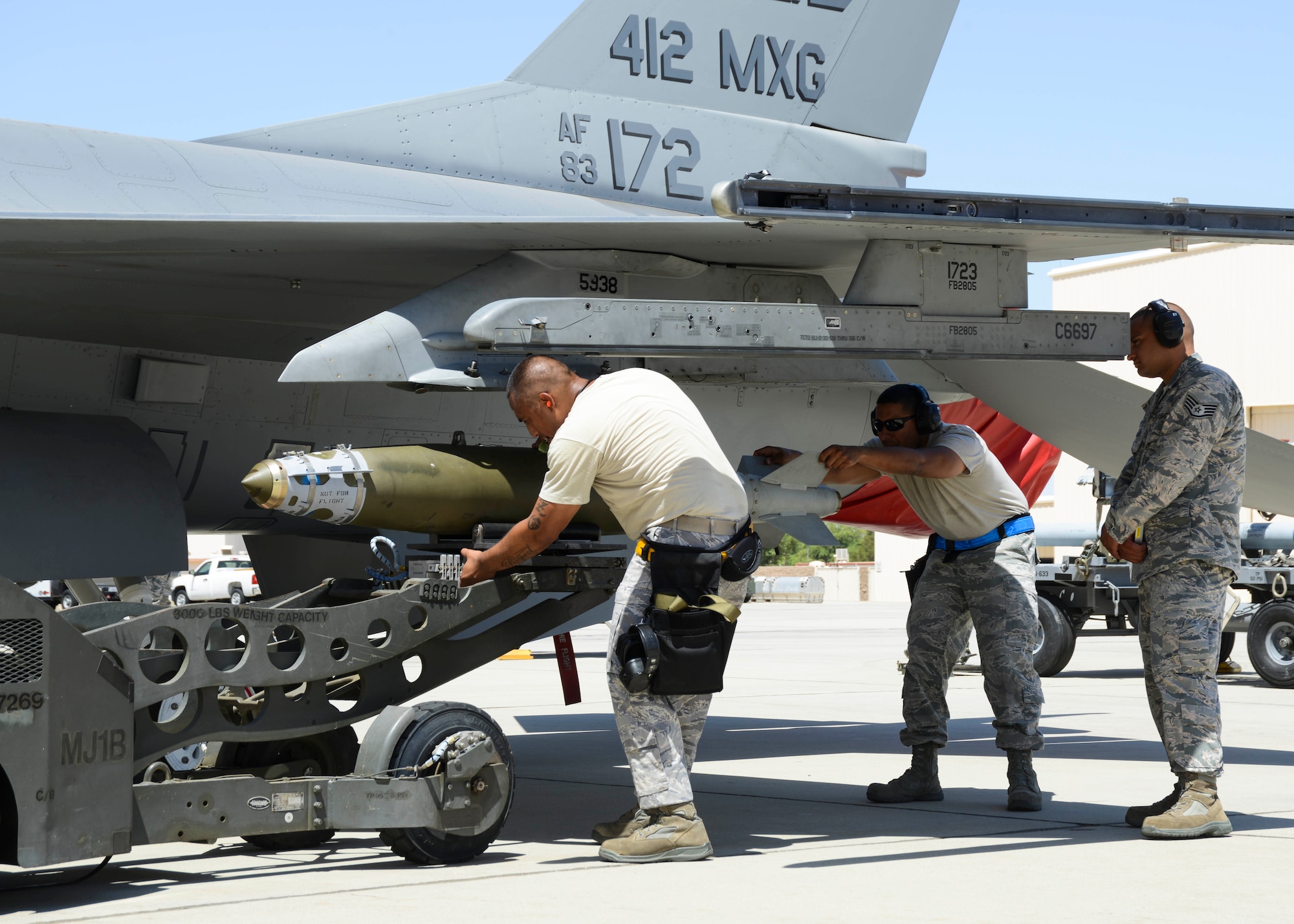 The 445th Aircraft Maintenance Unit team loads a GBU-38 to the F-16 Shadow’s Station 7 during the second quarter Weapons Load Competition July 7. Each team must load an air intercept missile and a guided bomb onto their aircraft with speed and precision. (U.S. Air Force photo by Rebecca Amber)