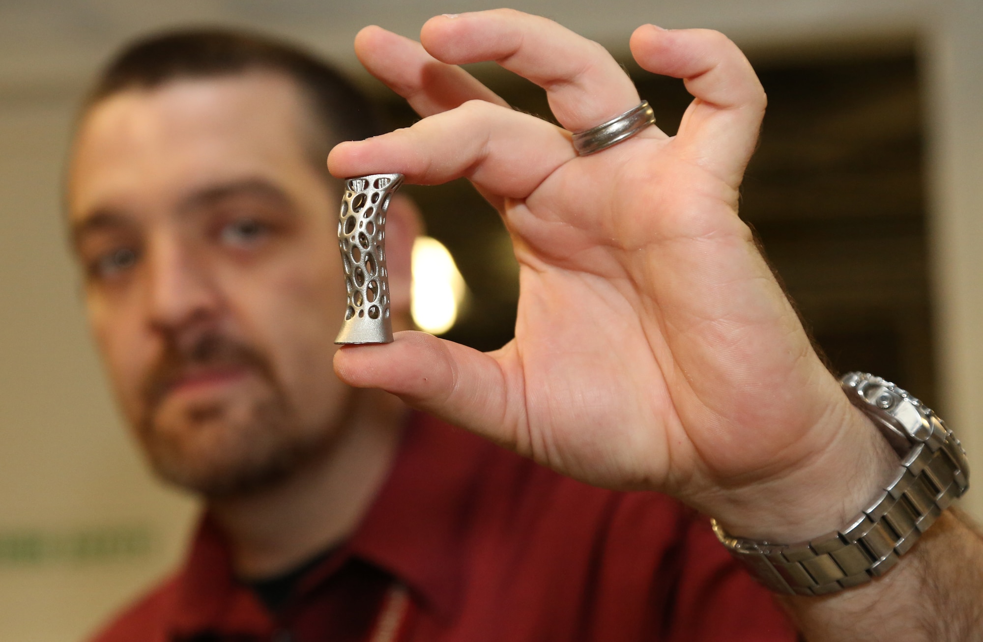 James Zunino, Picatinny Materials Engineer, displays an object that was created by an additive printing process. 3-D printing gives engineers the flexibility to quickly print items of various shapes, materials and structure. (Photo courtesy Erin Usawicz)