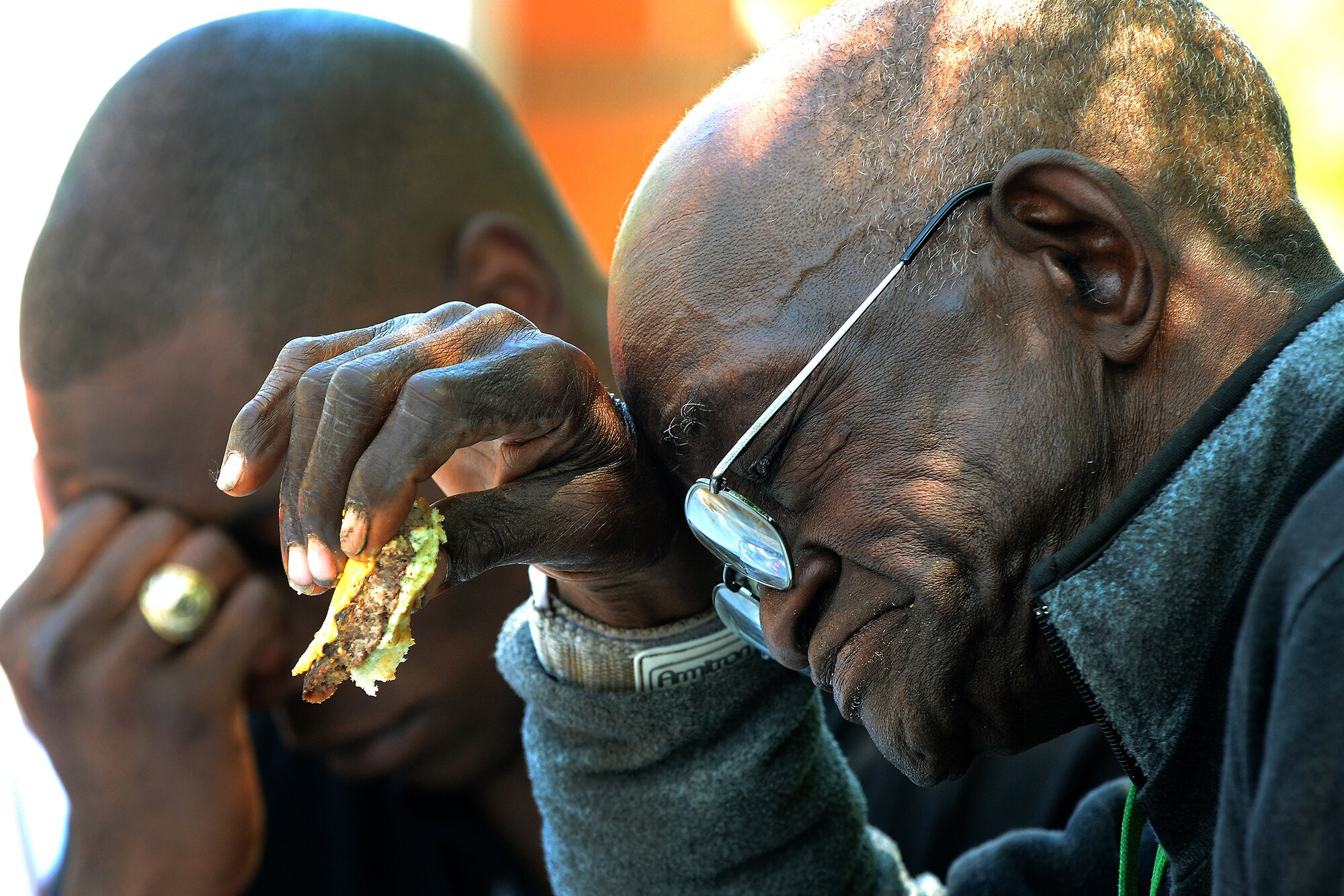 DAYTON, OHIO – First Lt. Justin Wilson, National Air and Space Intelligence Center, and retired Army veteran Marion Davis pray during the Dayton VA Medical Center picnic June 7, 2014. Members of the 88th Air Base Wing and 445th Airlift Wing gathered at the VA for food, fellowship and fun at the annual VAMC picnic, a mainstay since 1996 for VAMC residents. (U.S. Air Force photo/Tech. Sgt. Frank Oliver)