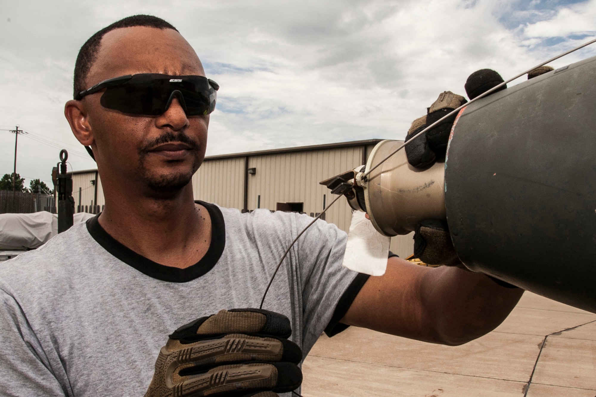 U.S. Air Force Tech. Sgt. Phillip Hughes, aircraft armament systems technician, 307th Aircraft Maintenance Squadron, checks the fuse setting on a Mk 82 training bomb during a munitions preparation inspection at Barksdale Air Force Base, La., June 26, 2014. Hughes is team chief on a four-man weapons load team for the B-52 Stratofortress. (U.S. Air Force photo by Master Sgt. Jeff Walston/Released)