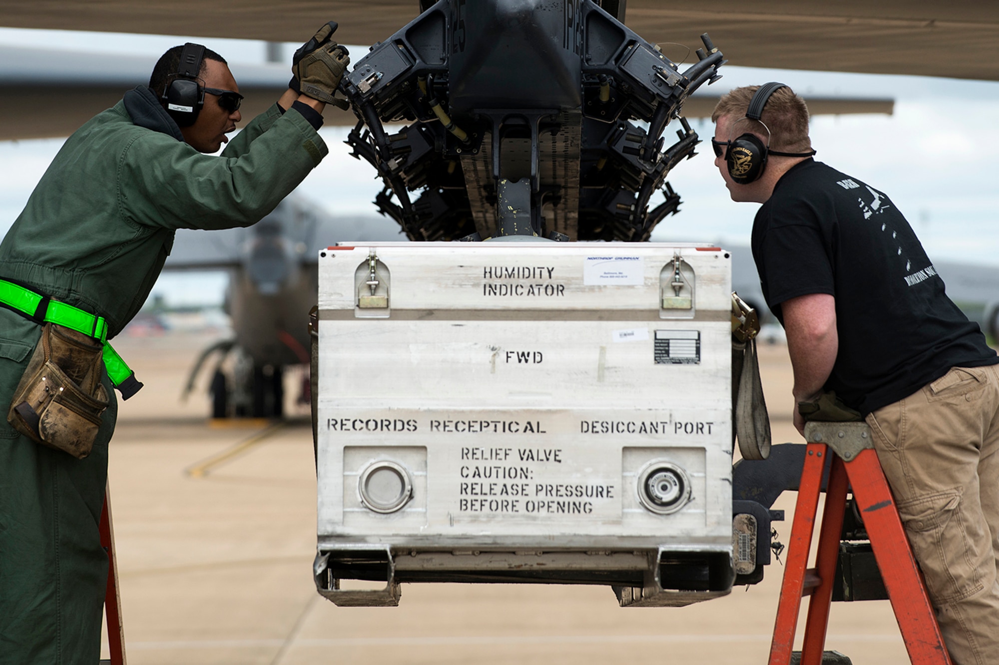 U.S. Air Force Tech. Sgts. Phillip Hughes and Robert Sowell keep a close watch on the alignment of a simulated AN/ASQ-236 Radar Pod during the installation on a 93rd Bomb Squadron B-52H Stratofortress, April 7, 2014, Barksdale Air Force Base, La. The pod is the same shape, weight and dimensions of the real pod, and was used for load training. (U.S. Air Force photo by Master Sgt. Greg Steele/Released)
