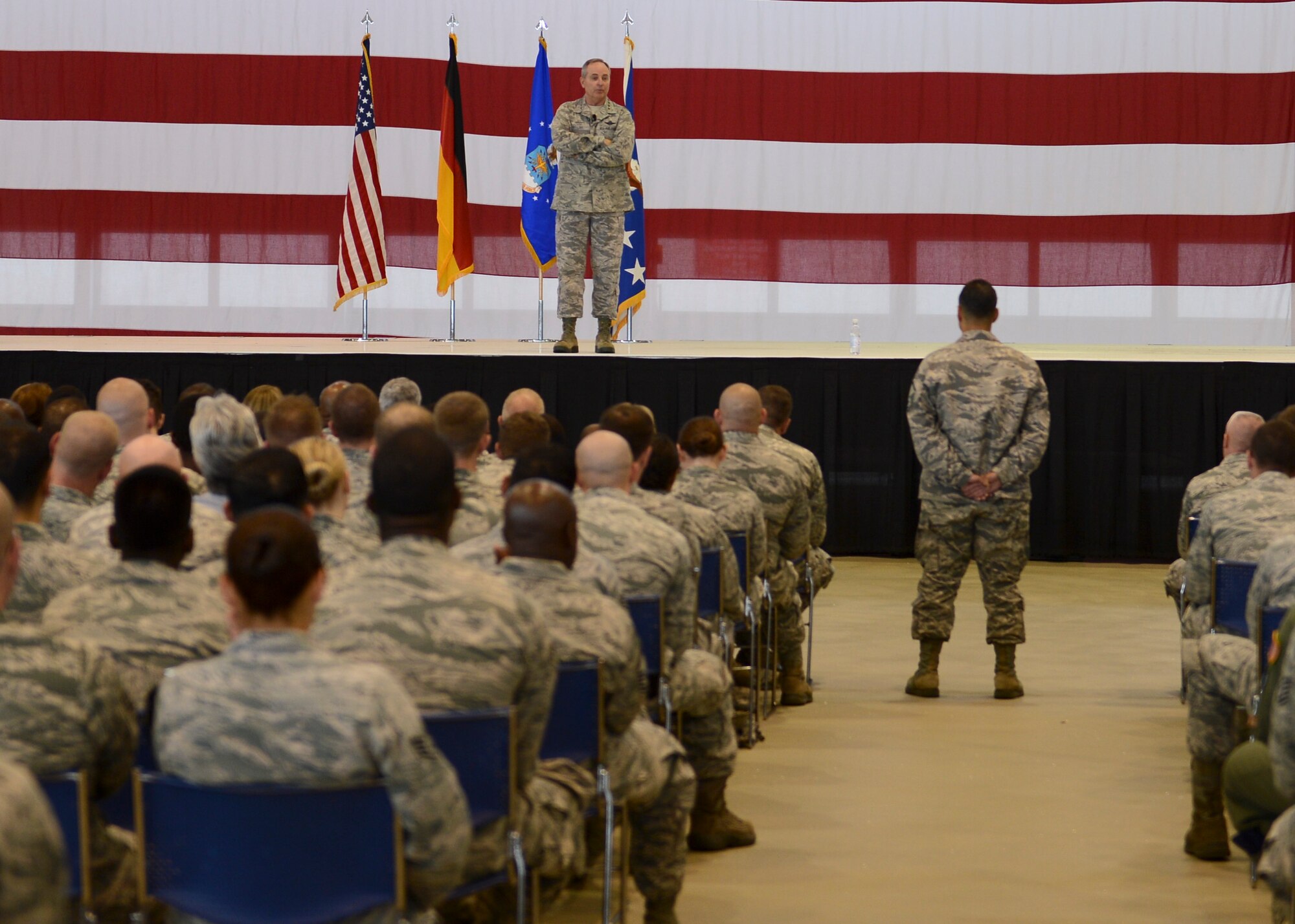 Air Force Chief of Staff Gen. Mark A. Welsh III, answers questions from an airman during an all-call July 8, 2014, Ramstein Air Base, Germany. Welsh and his wife, Betty, visited to interact with Airmen and discuss the state of the Air Force as well as gaining a better understanding of the responsibilities of Team Ramstein. As the senior uniformed Air Force officer, he is responsible for the organization, training and equipping of 690,000 active-duty, Guard, Reserve and civilian forces serving in the United States and overseas. Prior to his current position, he was U.S. Air Forces in Europe Commander. (U.S. Air Force photo/Airman 1st Class Michael Stuart) 