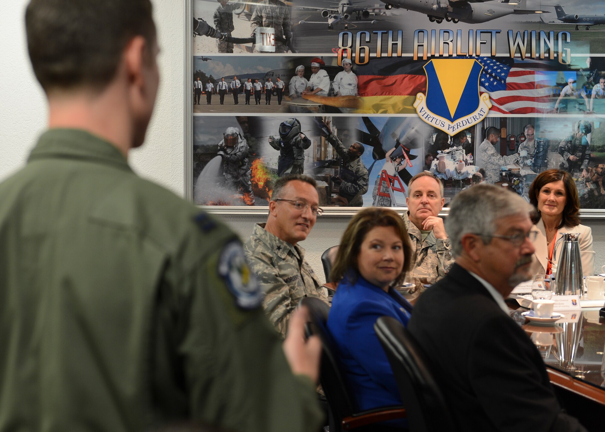 Air Force Chief of Staff Gen. Mark A. Welsh III, listens as Capt. Kyle Gauthier, 37th Airlift Sq. pilot, asks a question during a mission brief July 8, 2014, Ramstein Air Base, Germany. Welsh and his wife, Betty, visited to interact with Airmen and discuss the state of the Air Force as well as gaining a better understanding of the responsibilities of Team Ramstein. As the senior uniformed Air Force officer, he is responsible for the organization, training and equipping of 690,000 active-duty, Guard, Reserve and civilian forces serving in the United States and overseas. Prior to his current position, he was U.S. Air Forces in Europe Commander. (U.S. Air Force photo/Airman 1st Class Michael Stuart) 